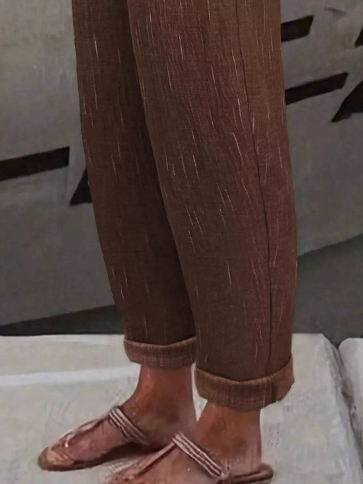 Brown loose fit cropped pants, cropped rolled cuff and fabric texture