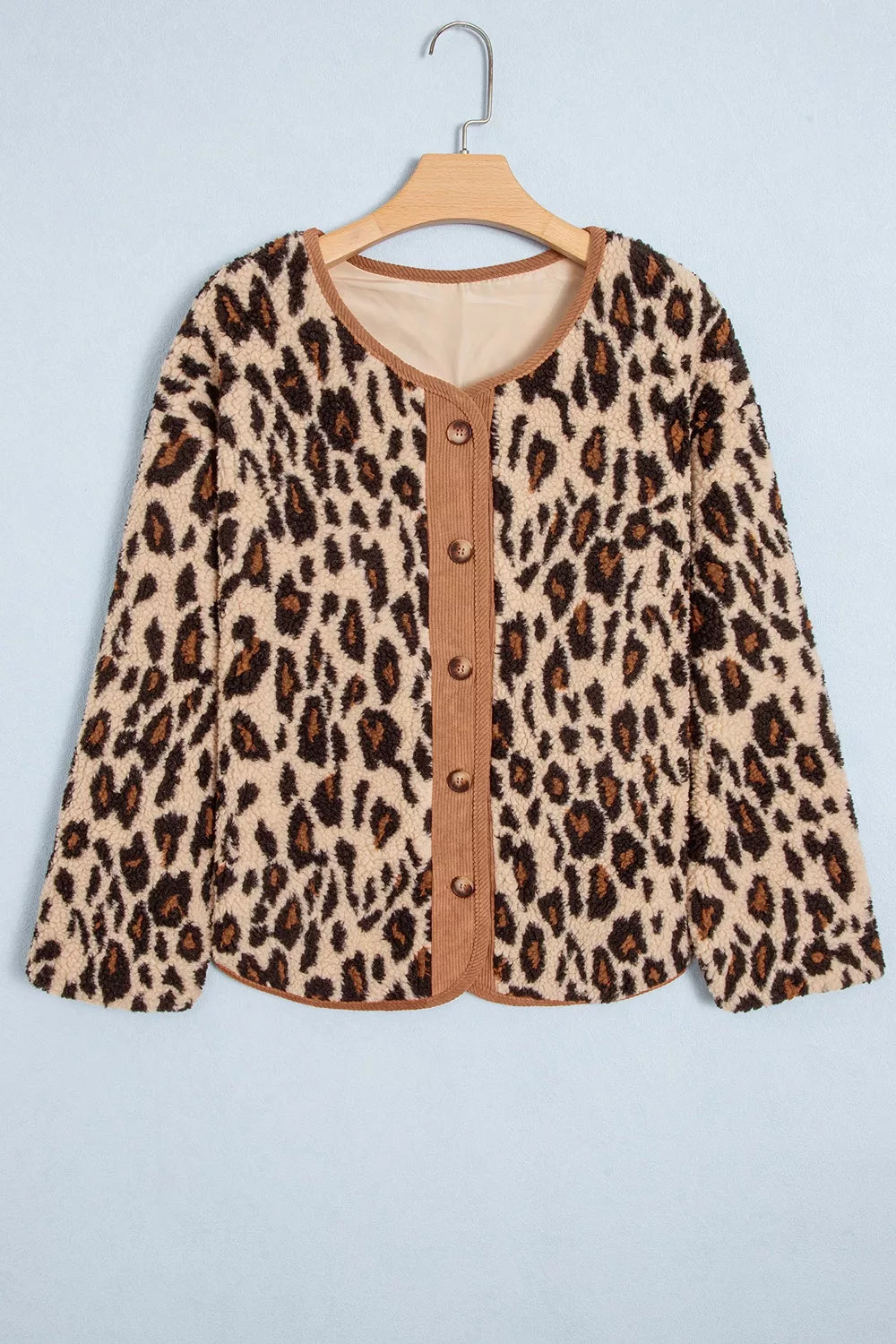 Leopard plush jacket with brown corduroy trim, front on hanger
