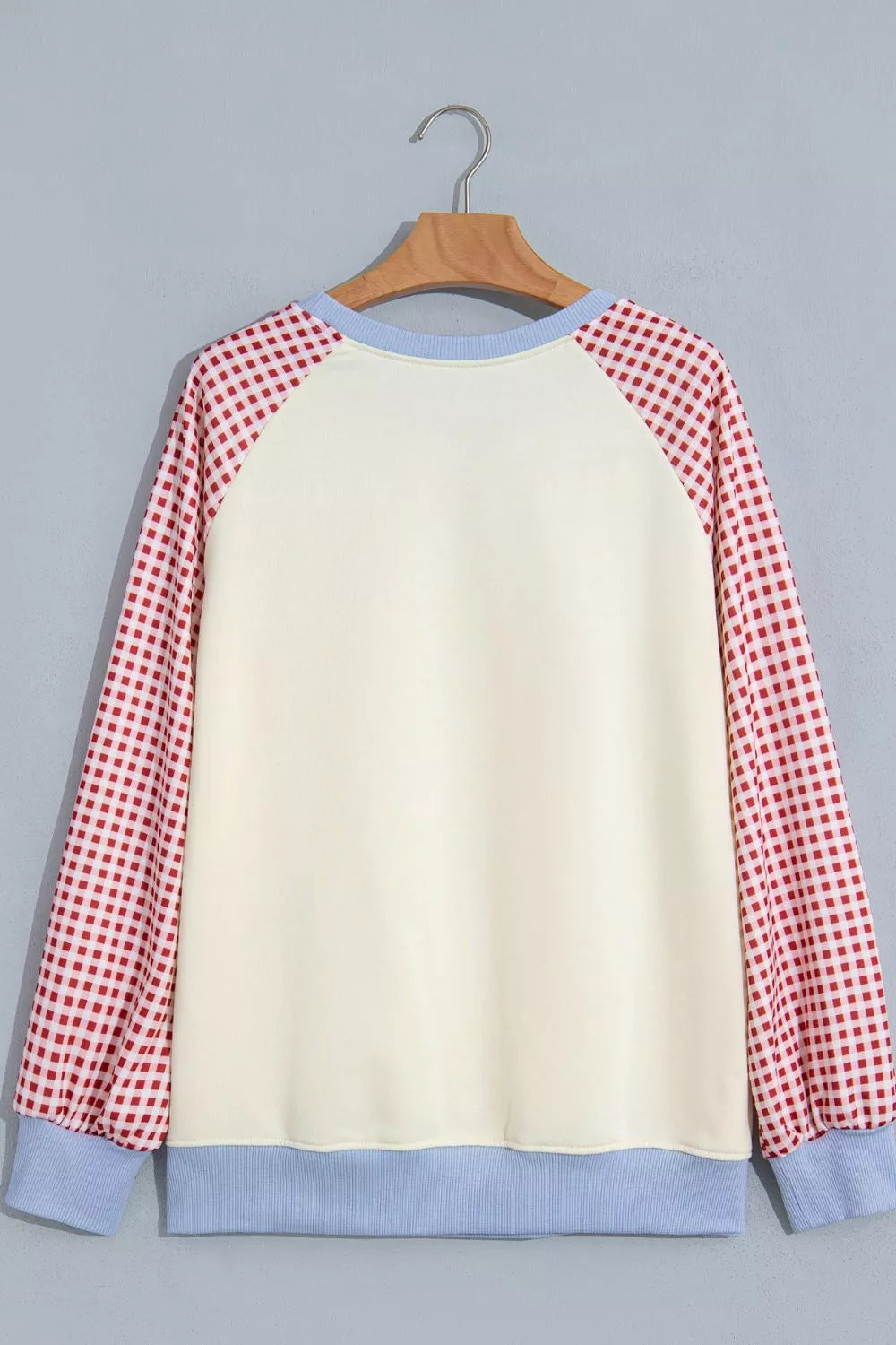 Cream Santa graphic sweatshirt with red plaid sleeves, back product view