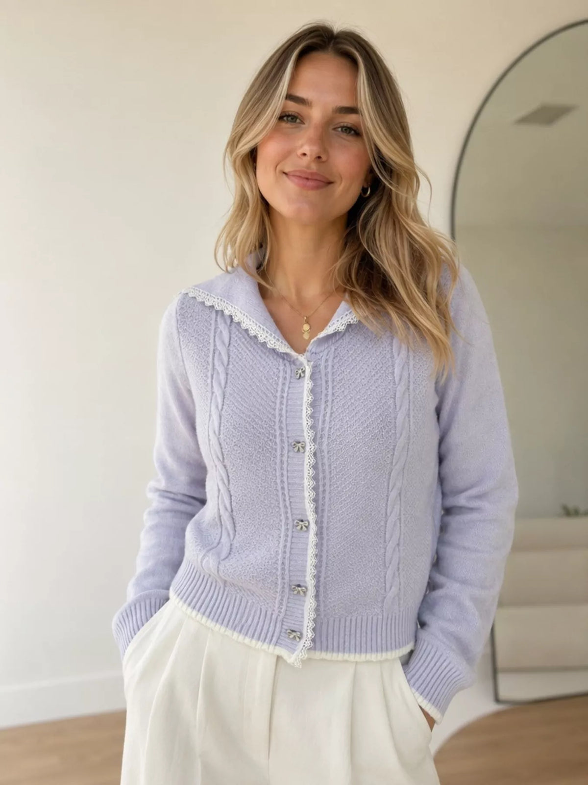 Lavender cable-knit cardigan with lace trim, front view.