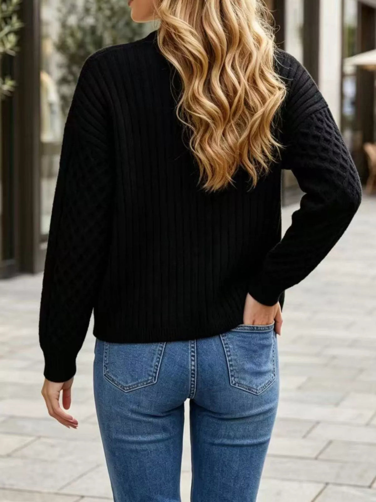 Black cable-knit v-neck button-front cardigan, back view.