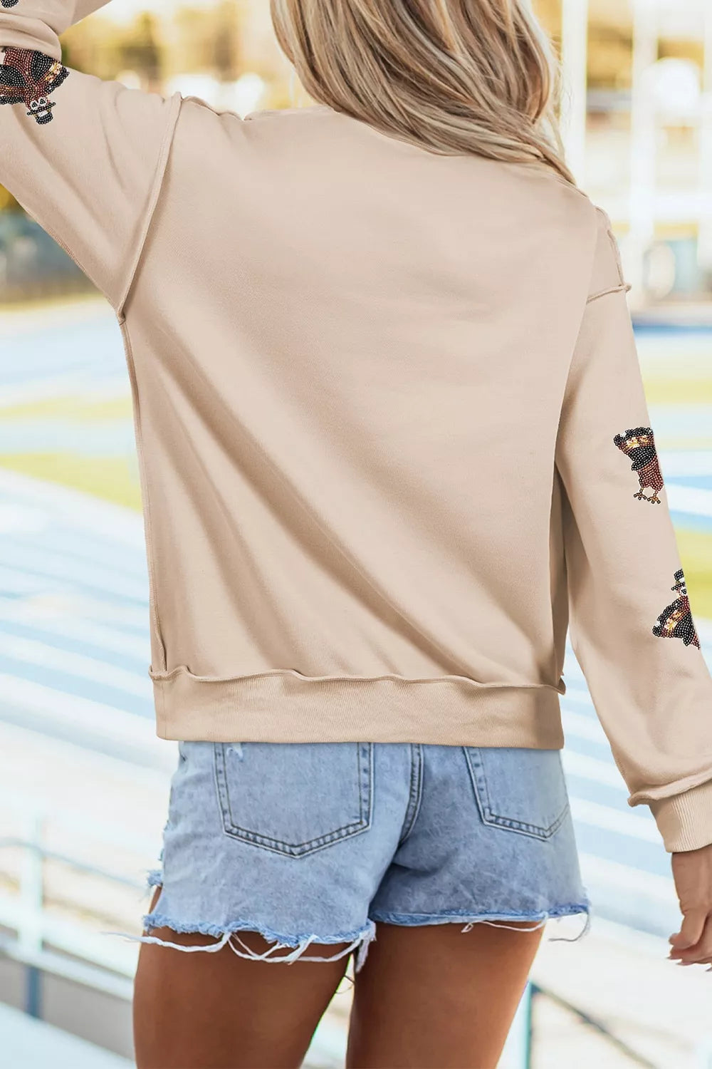 Sequin turkey mock-neck exposed-seam sweatshirt