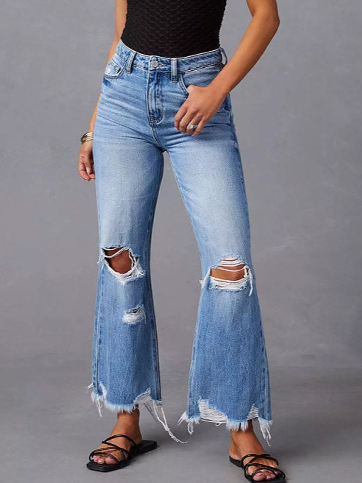 Blue distressed flare jeans — front view