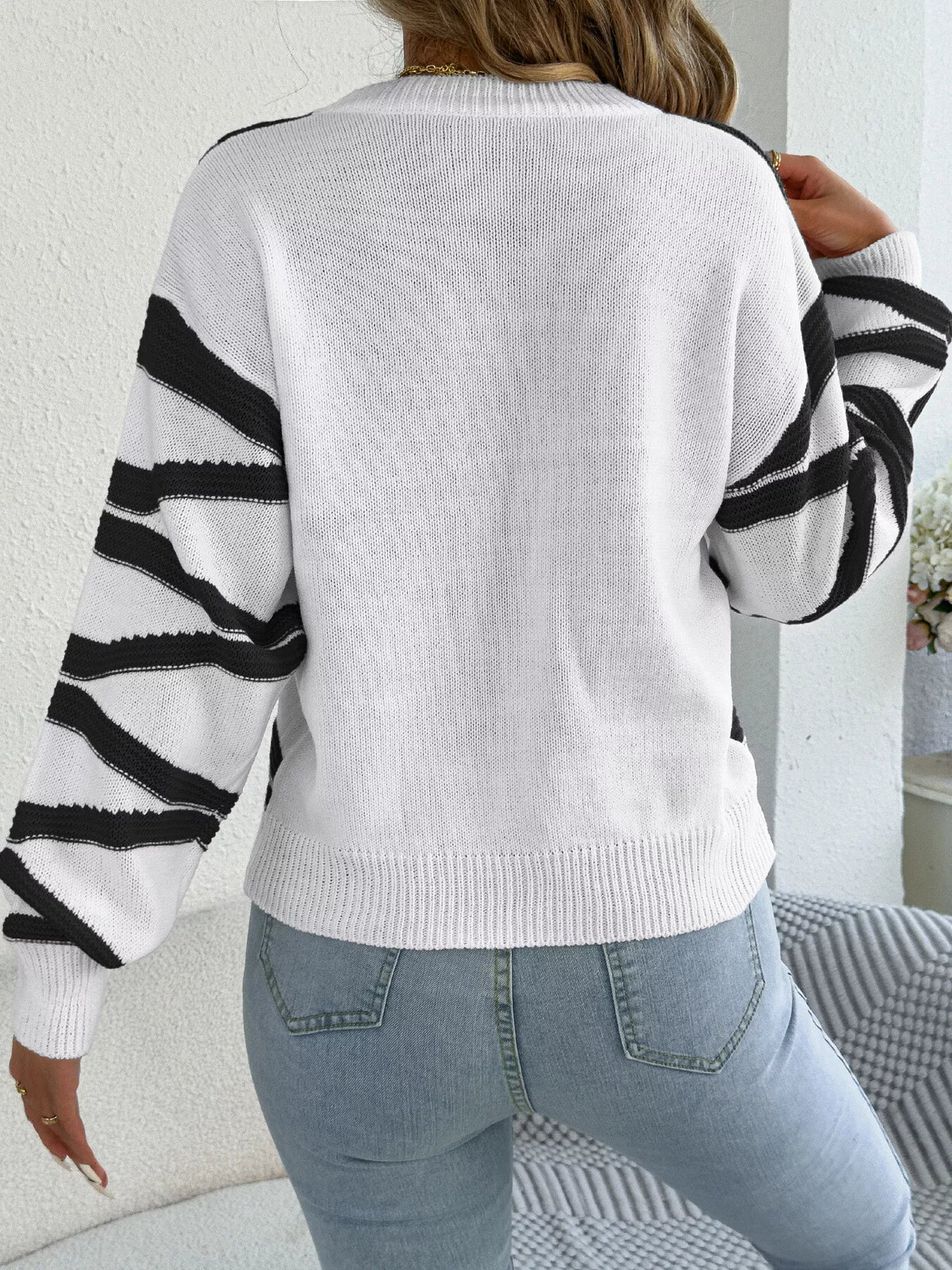 Black striped crew neck sweater, back view
