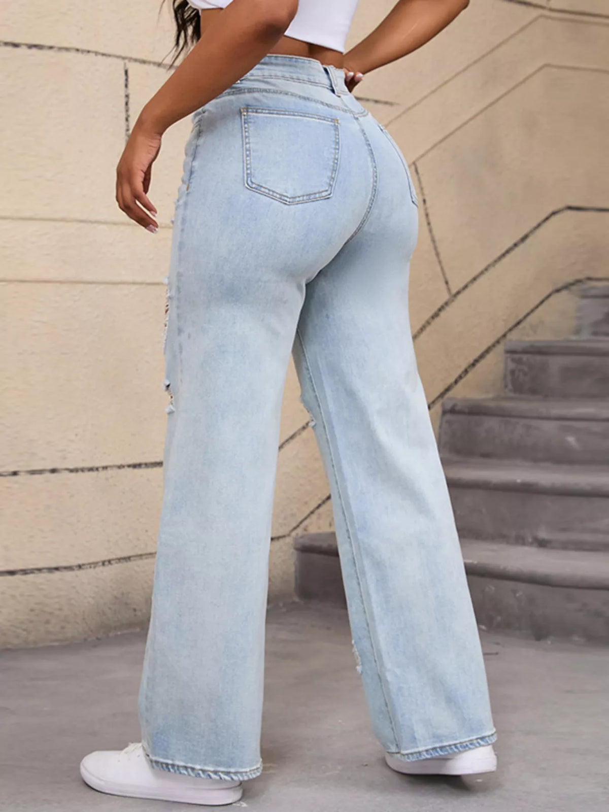 Light blue distressed wide-leg jeans, back side view