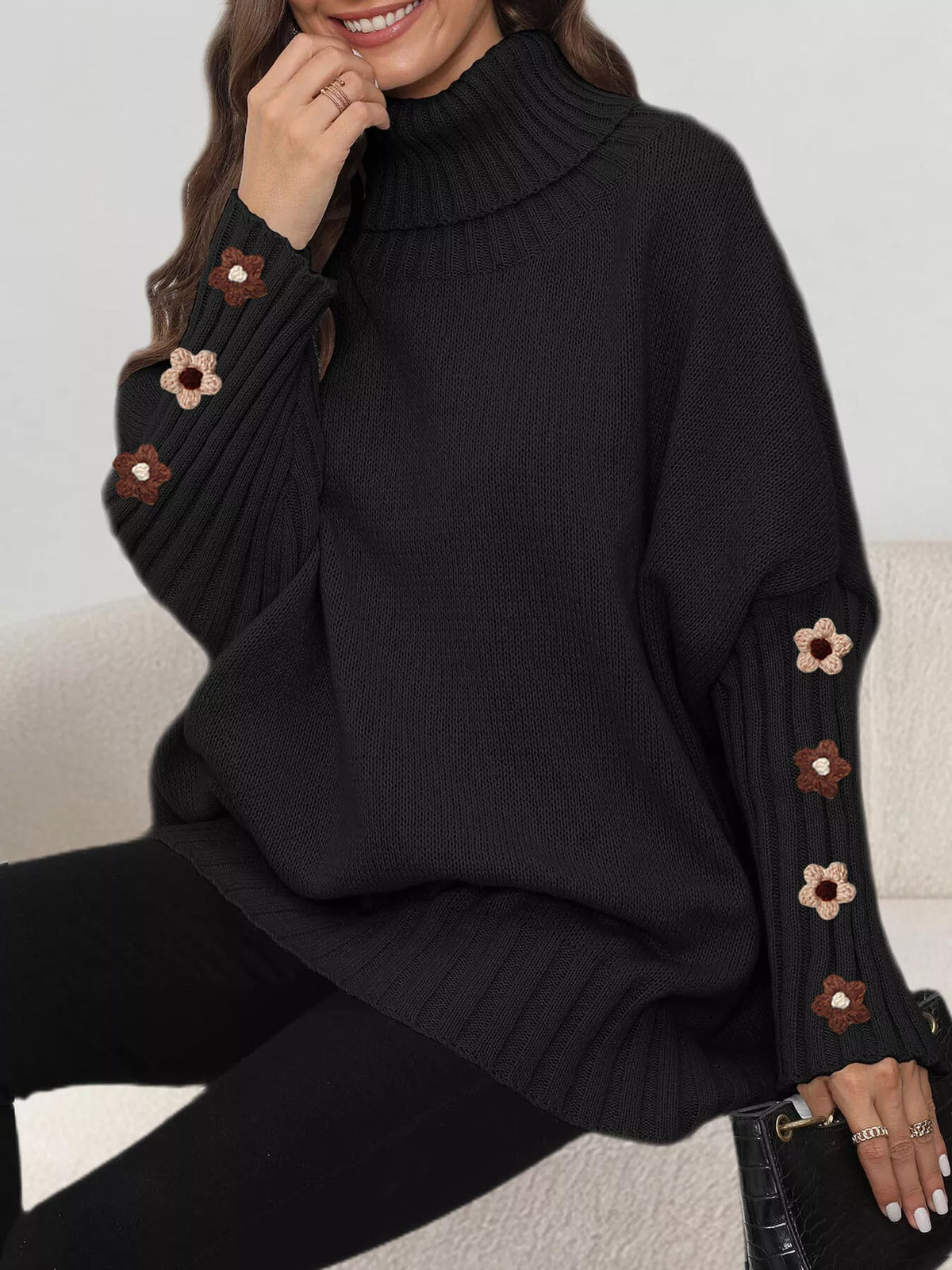 Black oversized floral sleeve turtleneck sweater, seated view