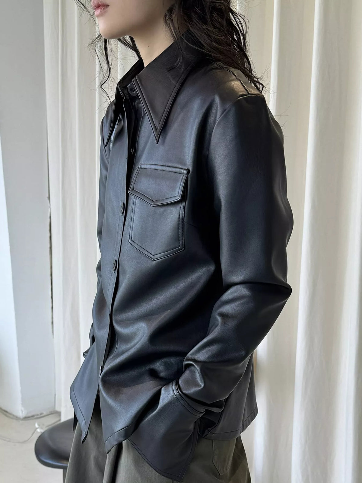 Black faux leather button-front jacket — side view