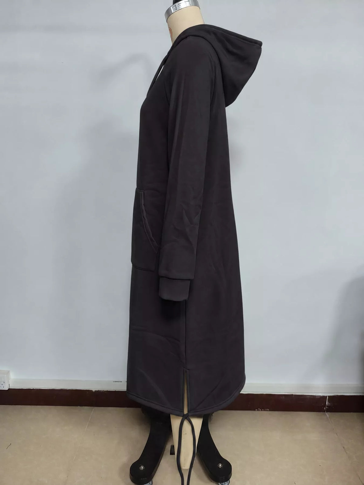Black hooded sweatshirt midi dress with drawstring hem, side view
