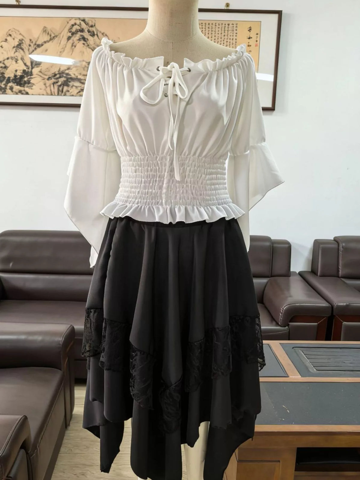 Black skirt and white top off-shoulder top, waist band and skirt set — front view