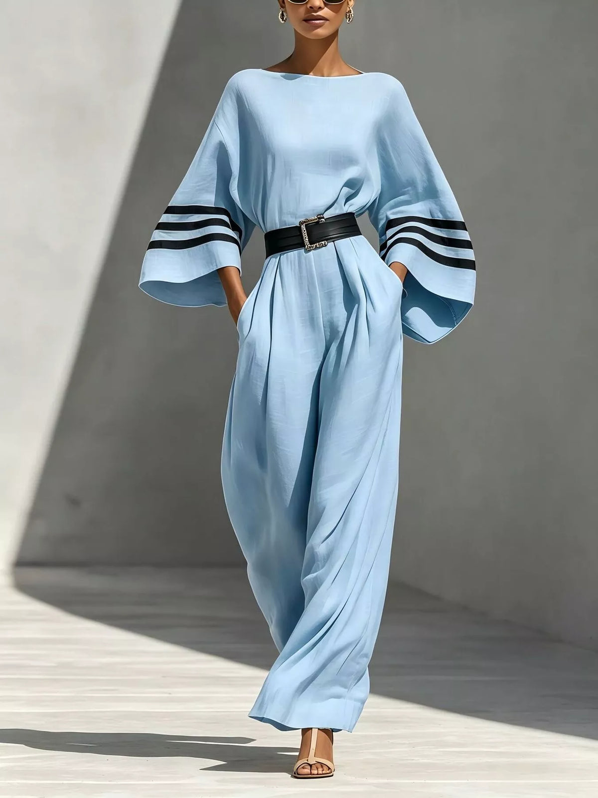 Light blue wide-sleeve jumpsuit with striped trim, full front view.