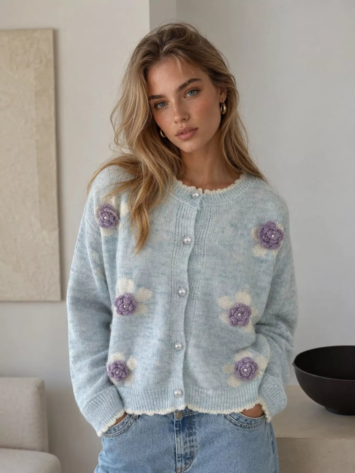 Floral-applique knit cardigan in light blue, front view with jeans