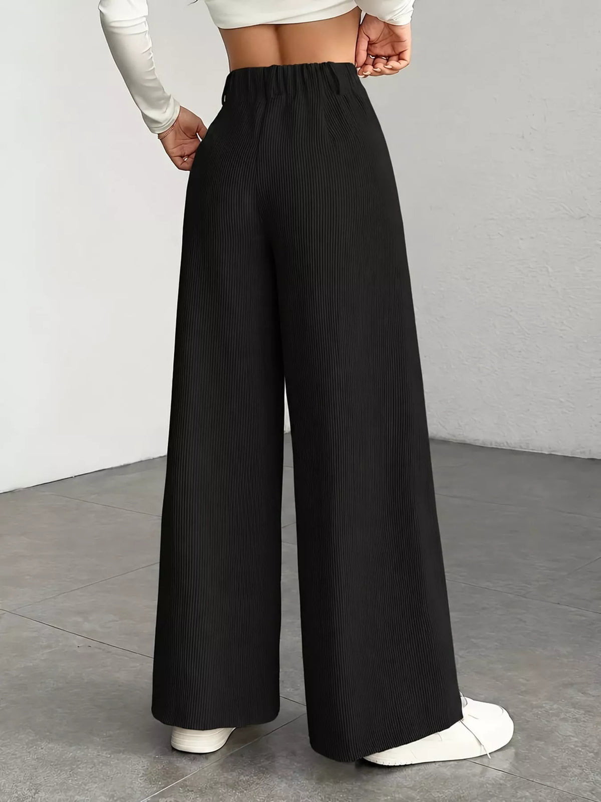 Black high-waisted wide-leg pants, back view