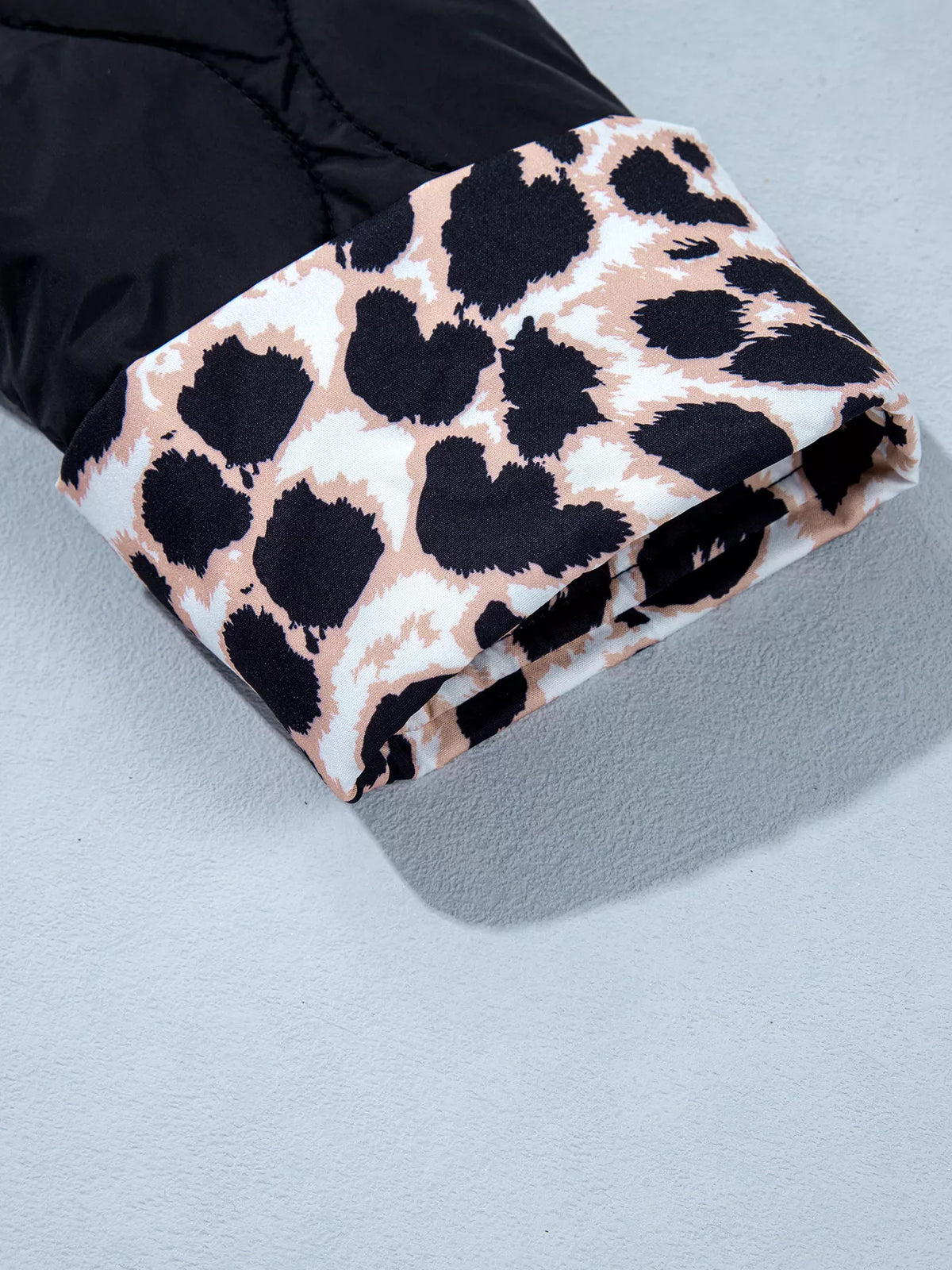 Quilted Leopard Cuff Button Down Puffer Jacket in black, construction detail