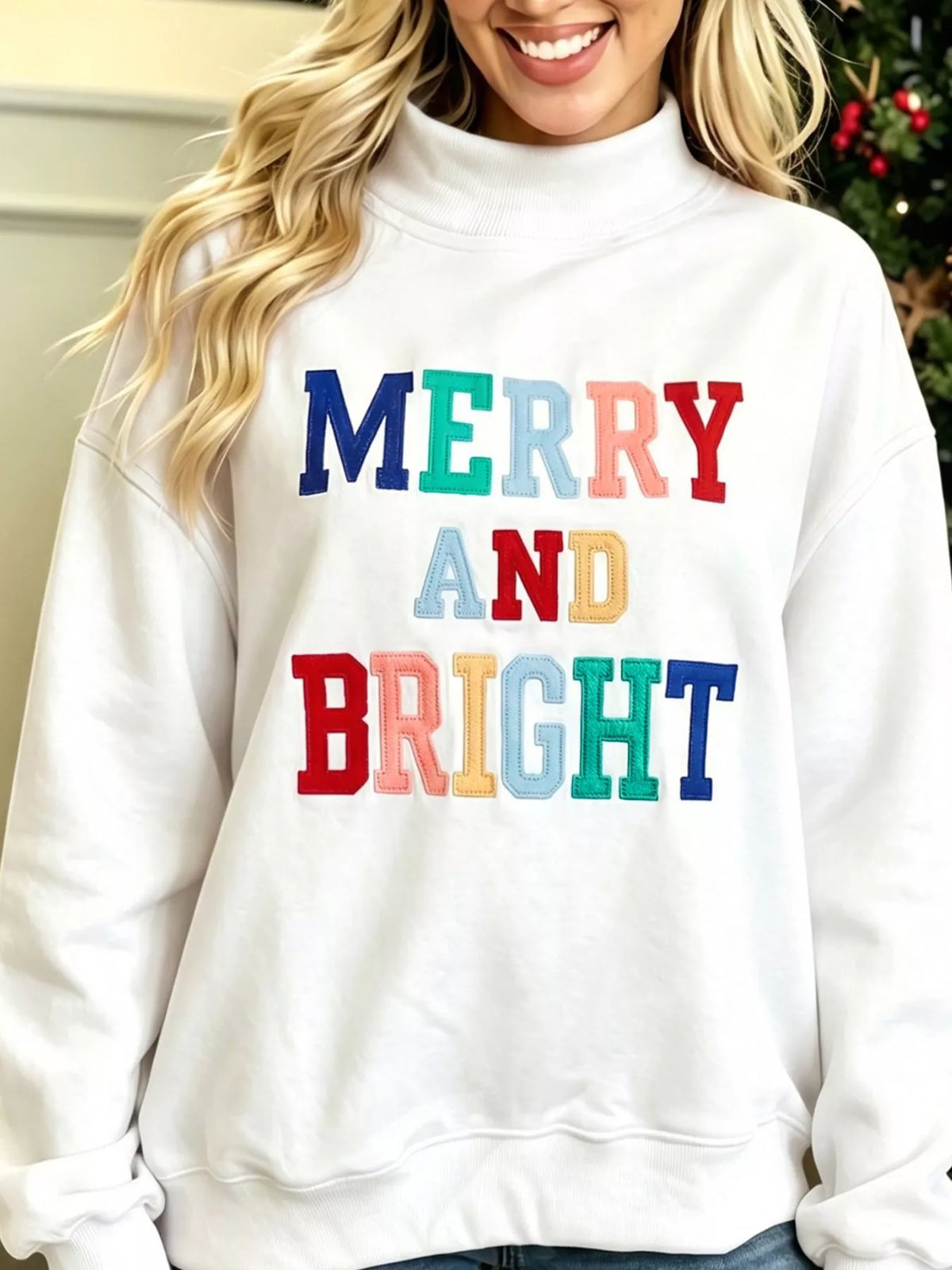 MERRY AND BRIGHT sweatshirt, white slogan close up