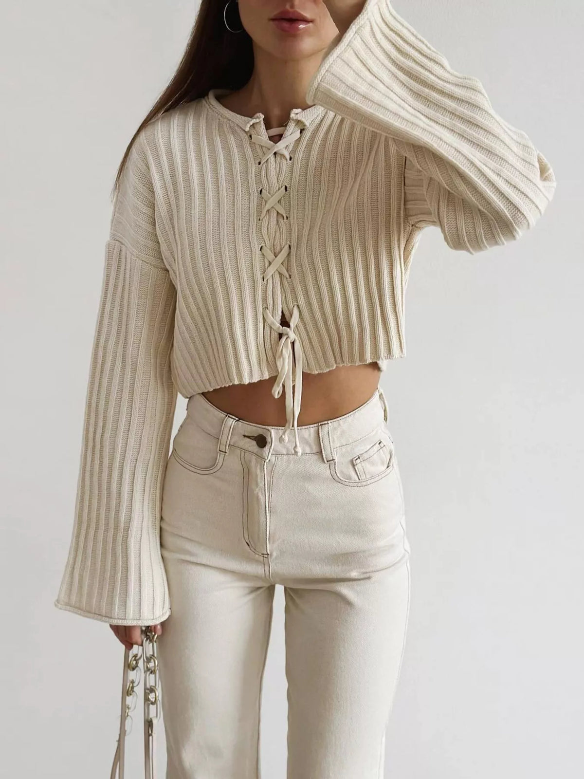 Ivory ribbed lace-up cropped sweater, front view.
