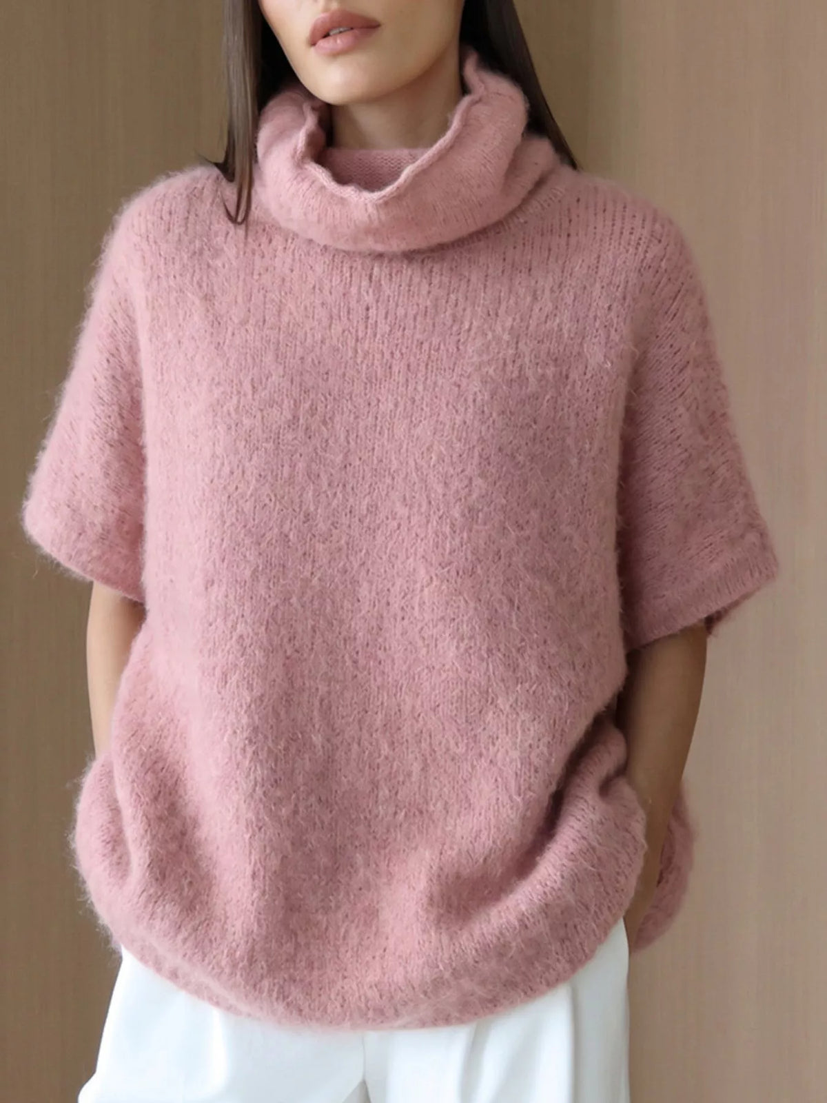 Fuzzy short-sleeve turtleneck sweater in pink, front view showing texture