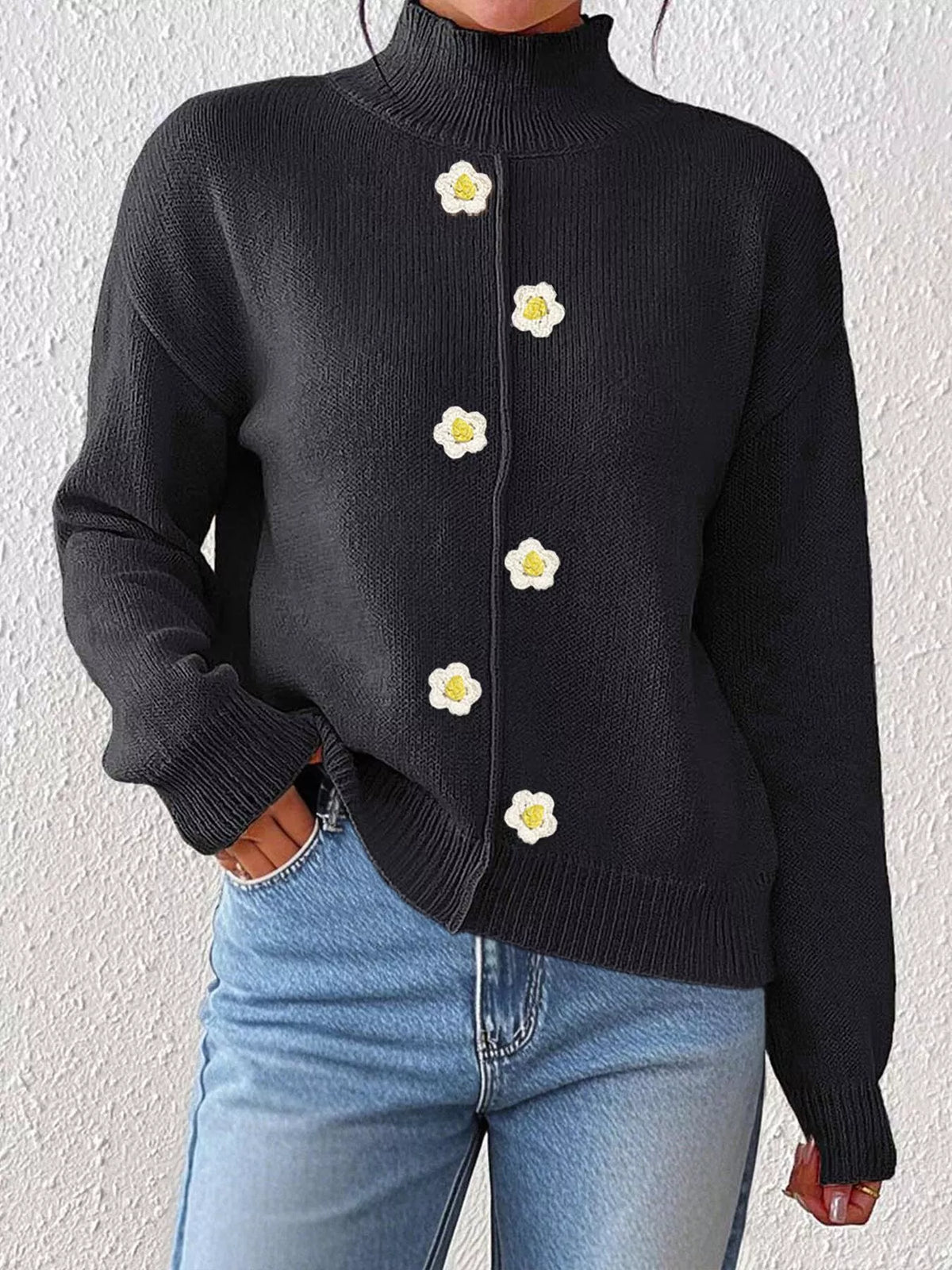 Black floral applique mock-neck sweater, front showing floral appliques.