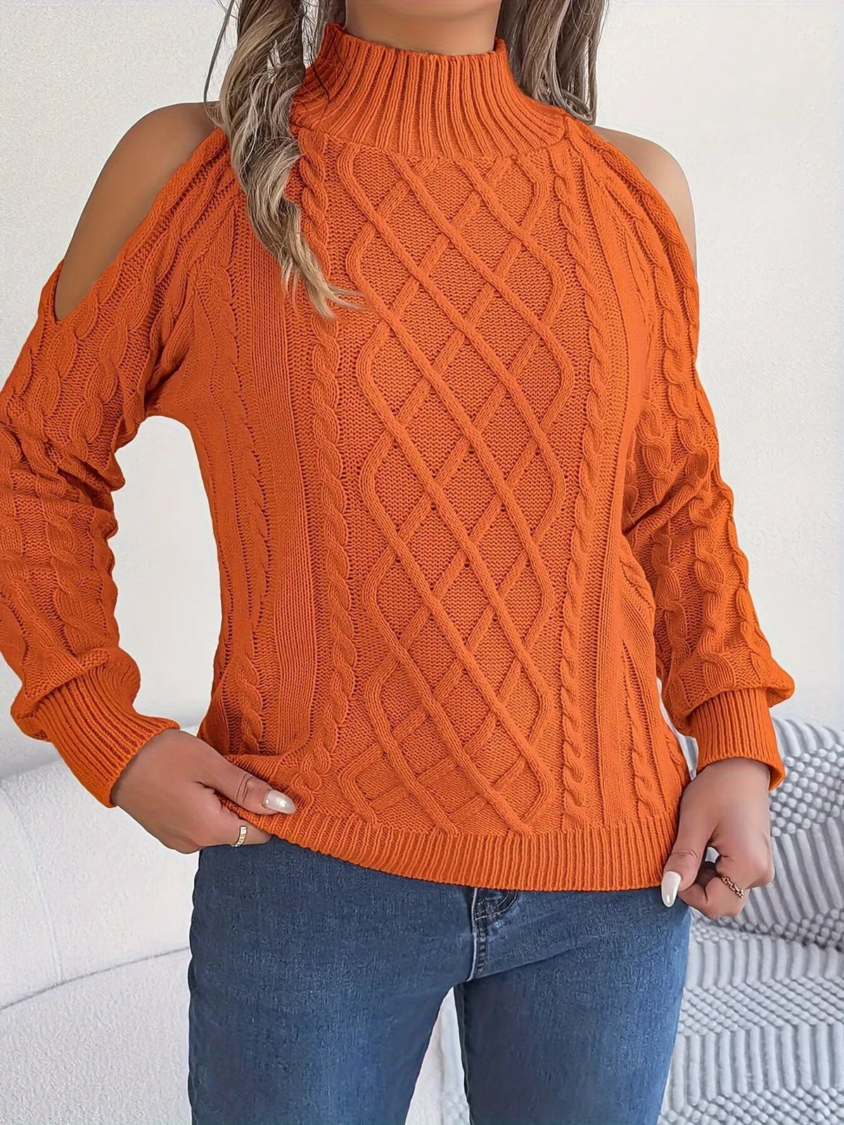 Orange cold-shoulder cable-knit sweater, untucked front view.