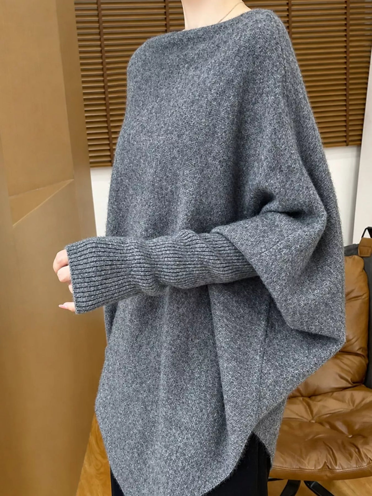 Gray asymmetrical lantern sleeve sweater — side view