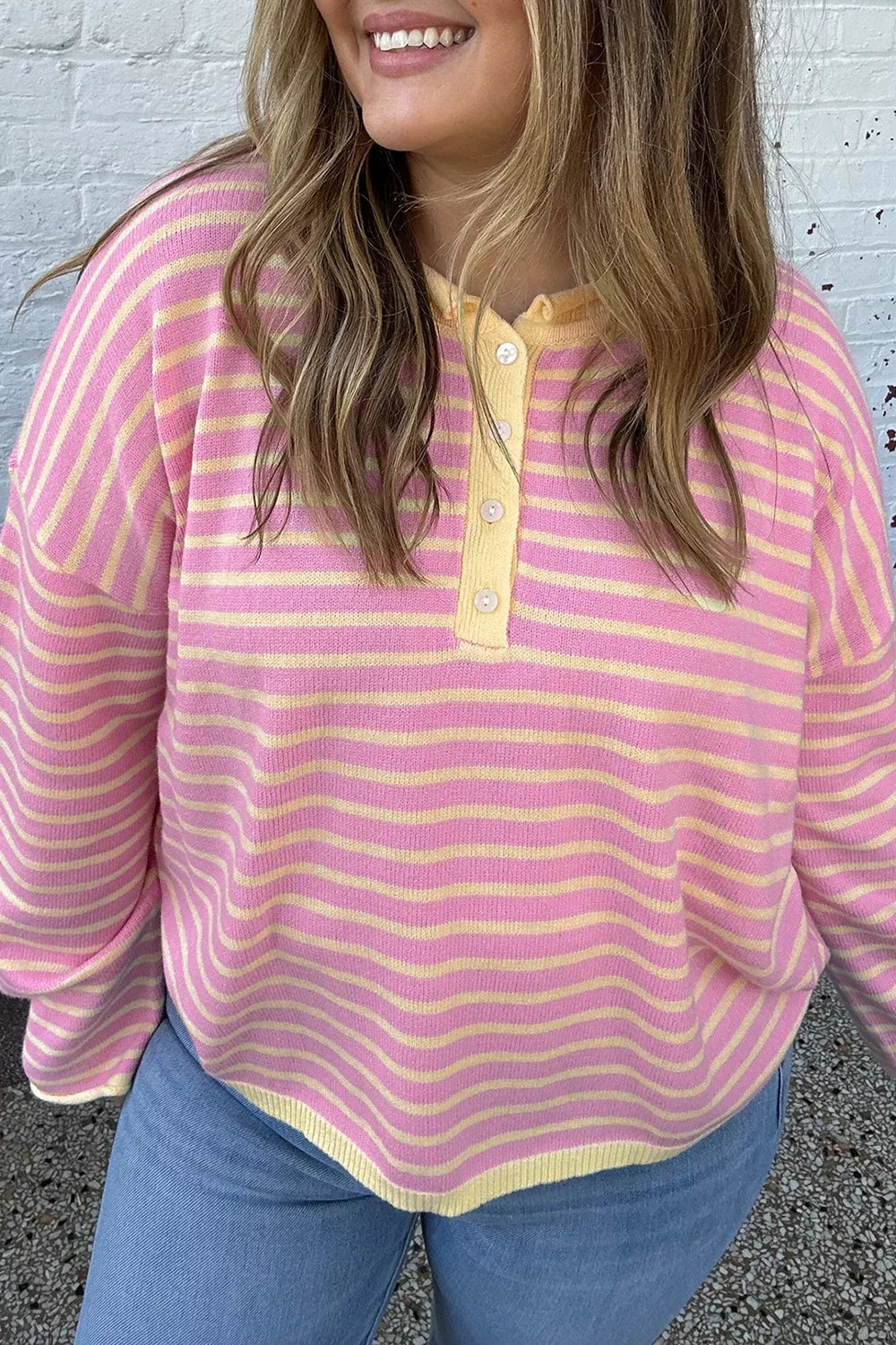 Pink and yellow striped button-detail sweater, front view
