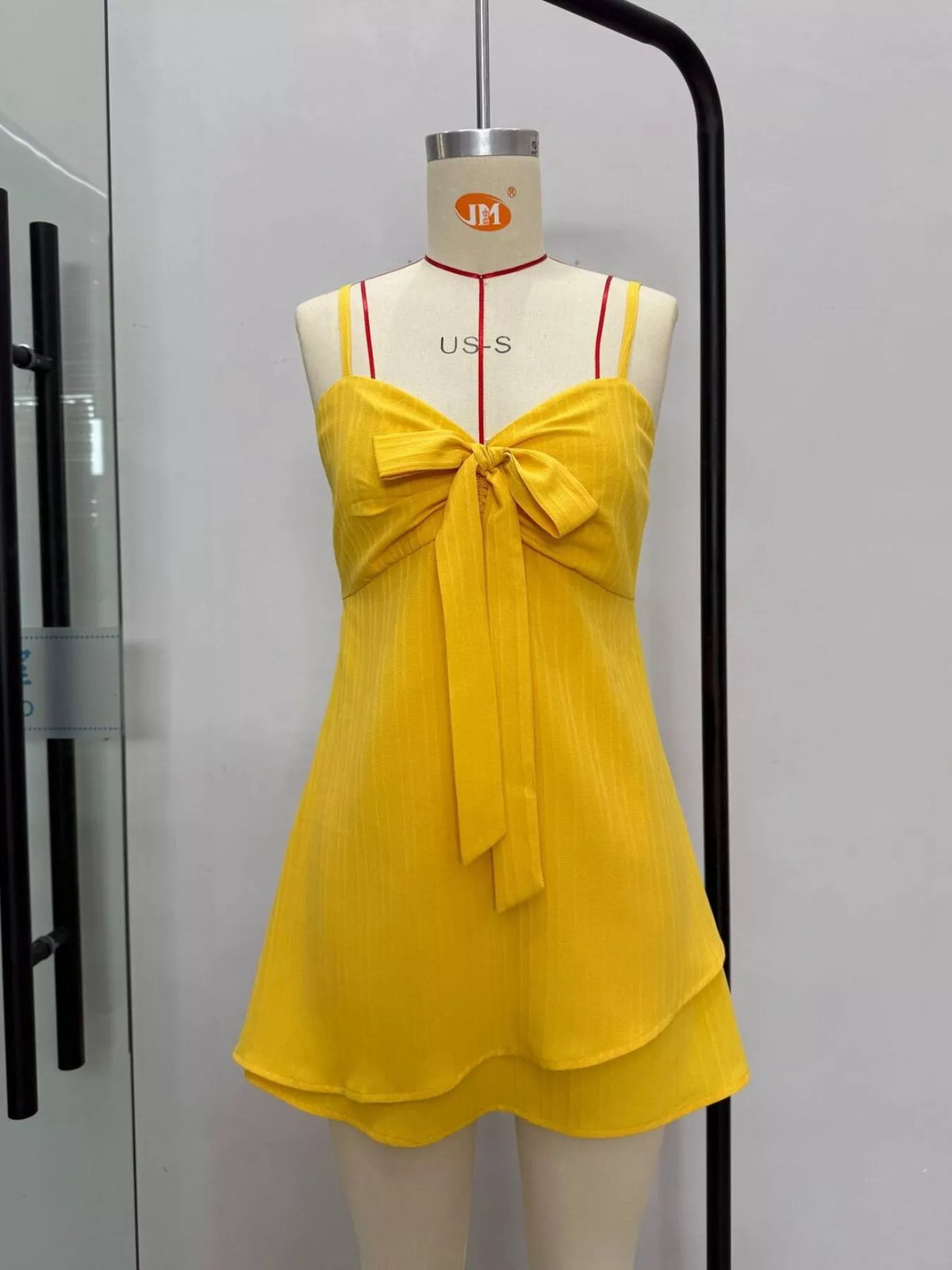 Yellow spaghetti strap bow-front layered mini dress