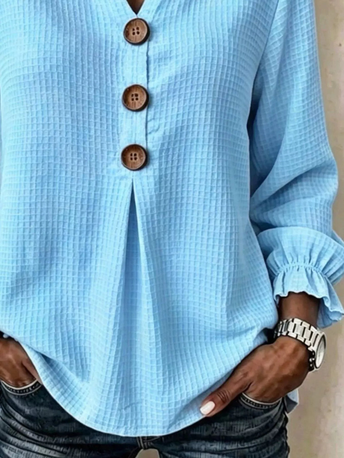 Light blue waffle knit blouse, waffle texture and flounce cuff