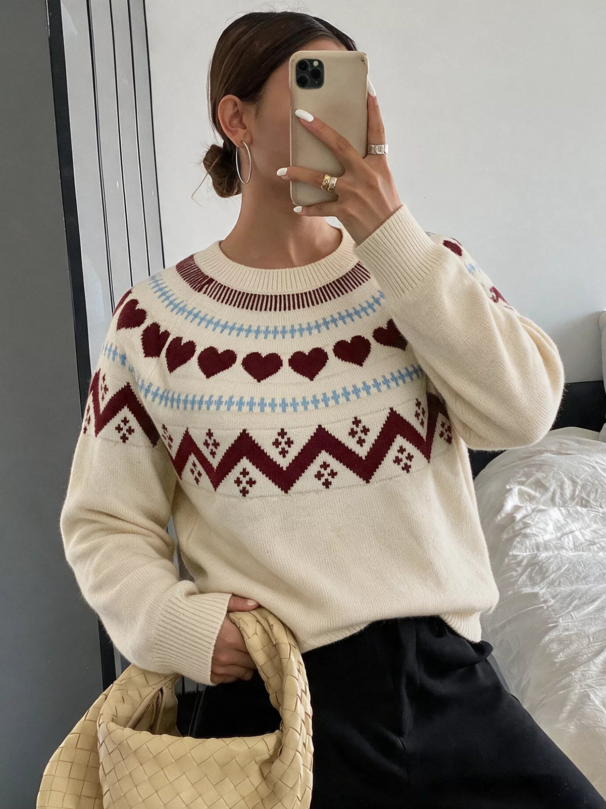 Cream heart-patterned crew neck sweater, front styled view