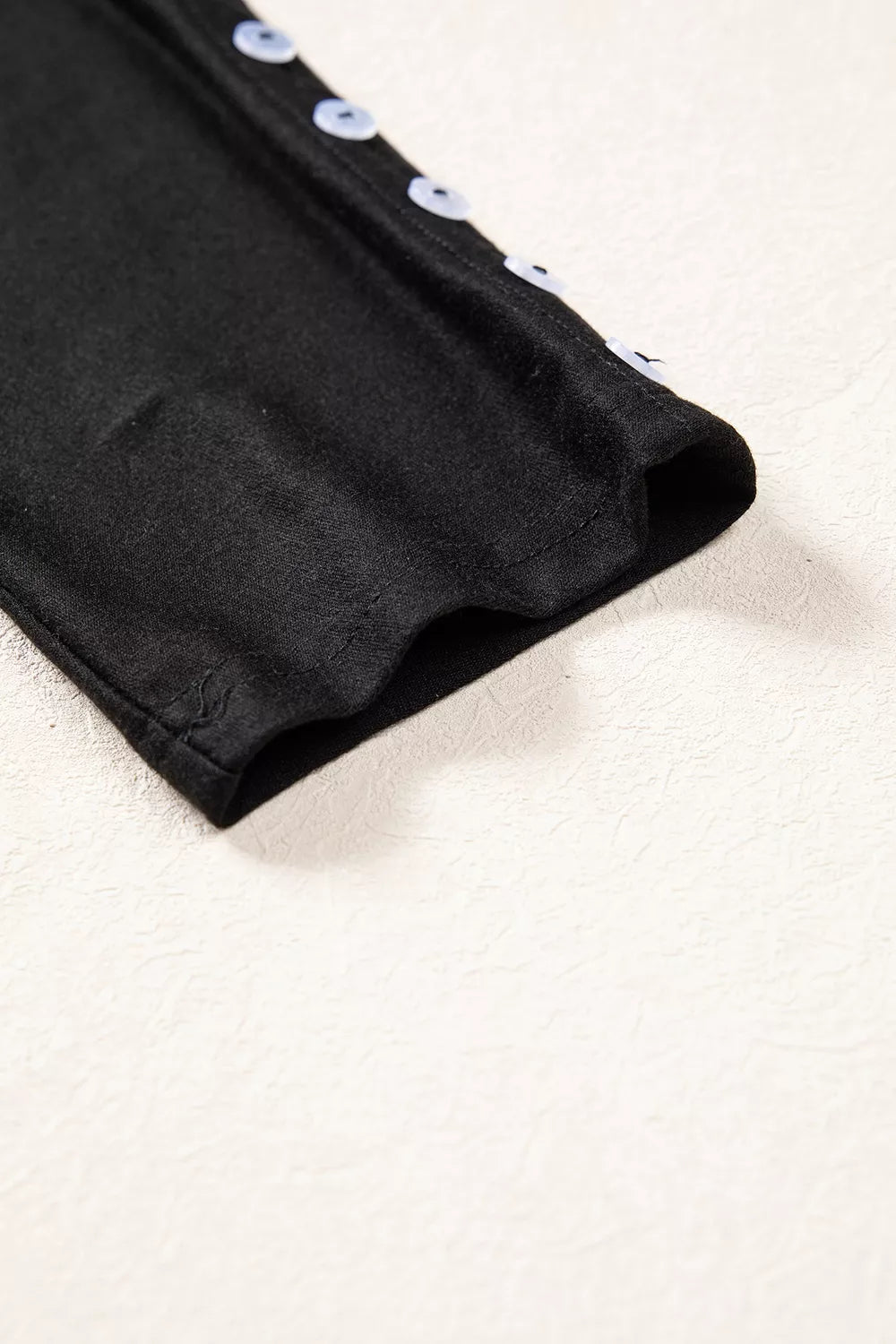 Black off-shoulder button-detail three-quarter sleeve top, sleeve detail