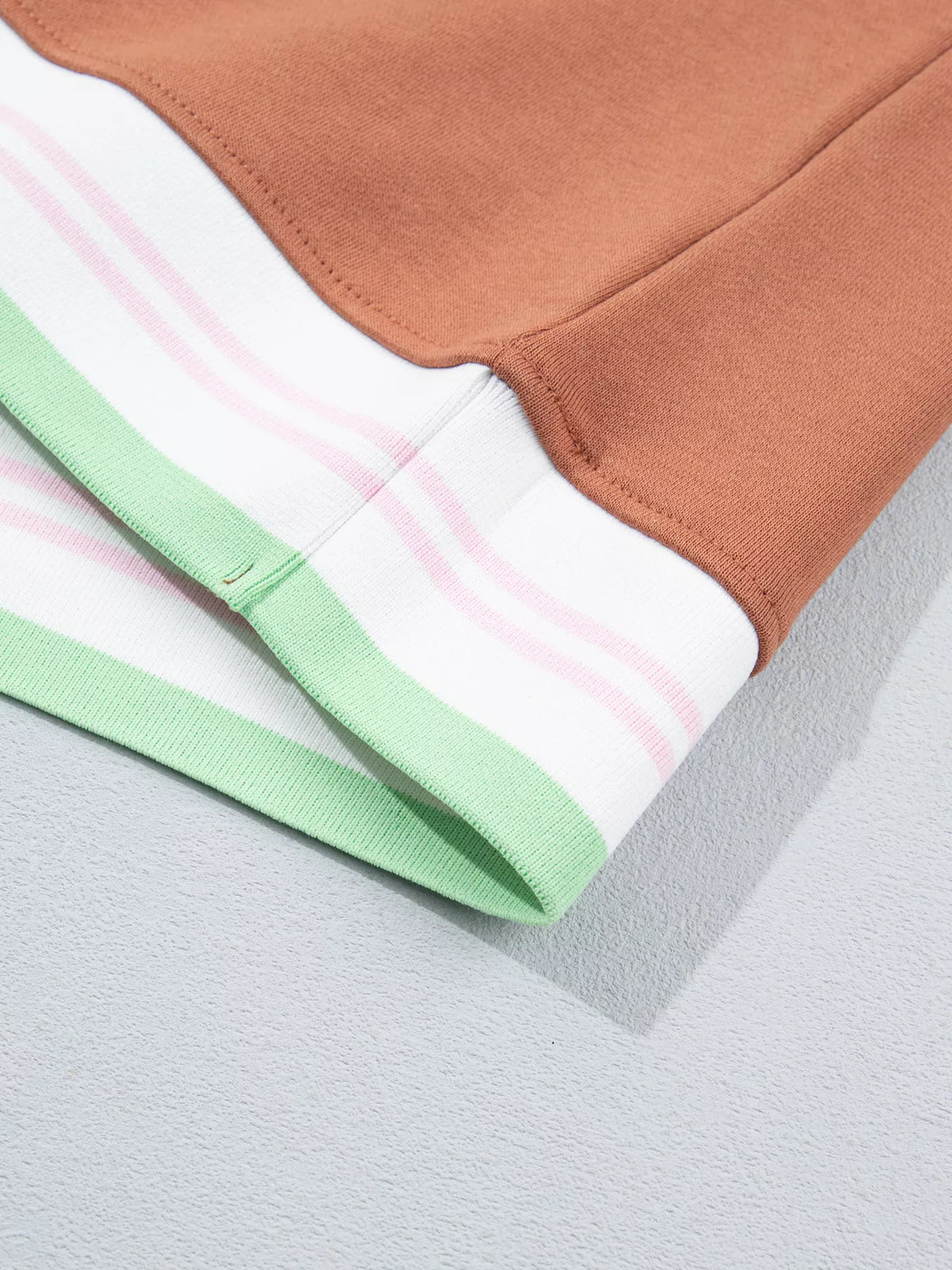 Brown sweatshirt with contrast striped ribbed trim, hem detail