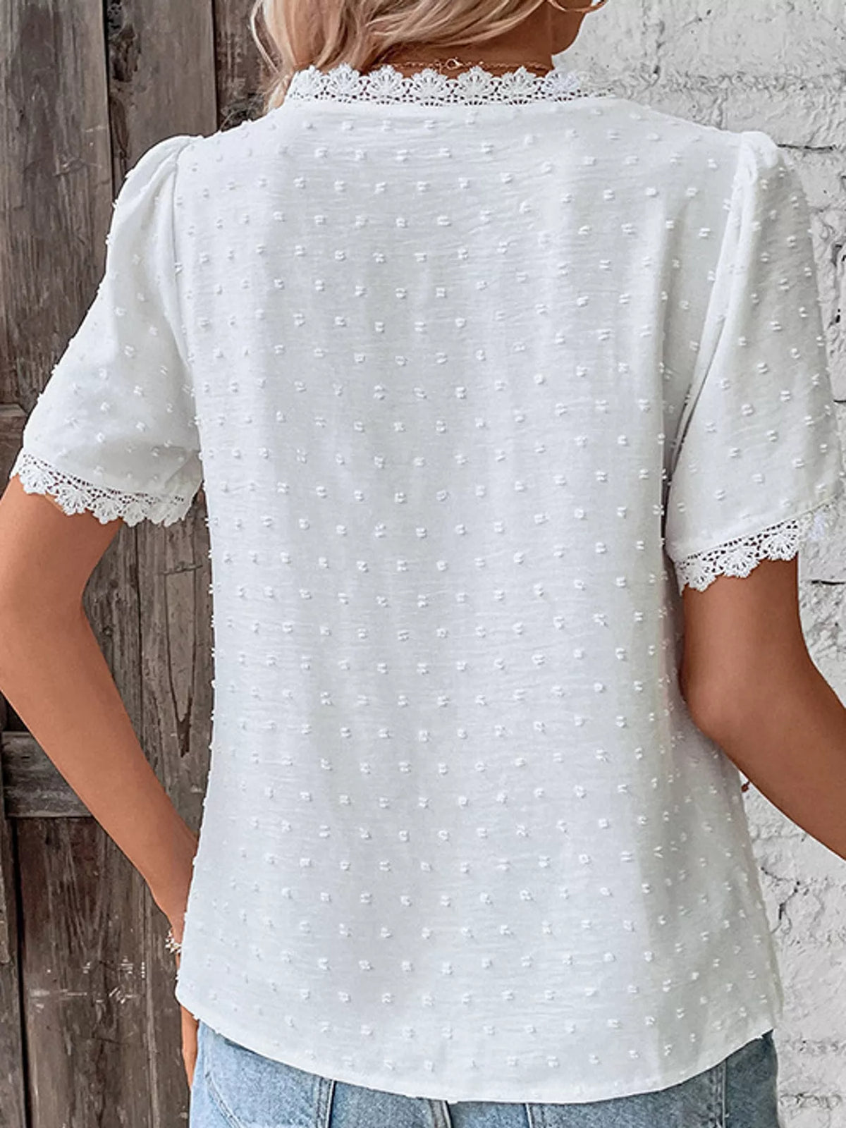 White swiss dot v-neck blouse with lace trim, back view