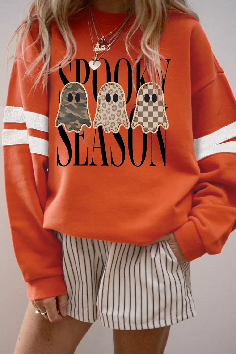 Spooky Season Ghost Striped Sleeve Sweatshirt in orange, front view