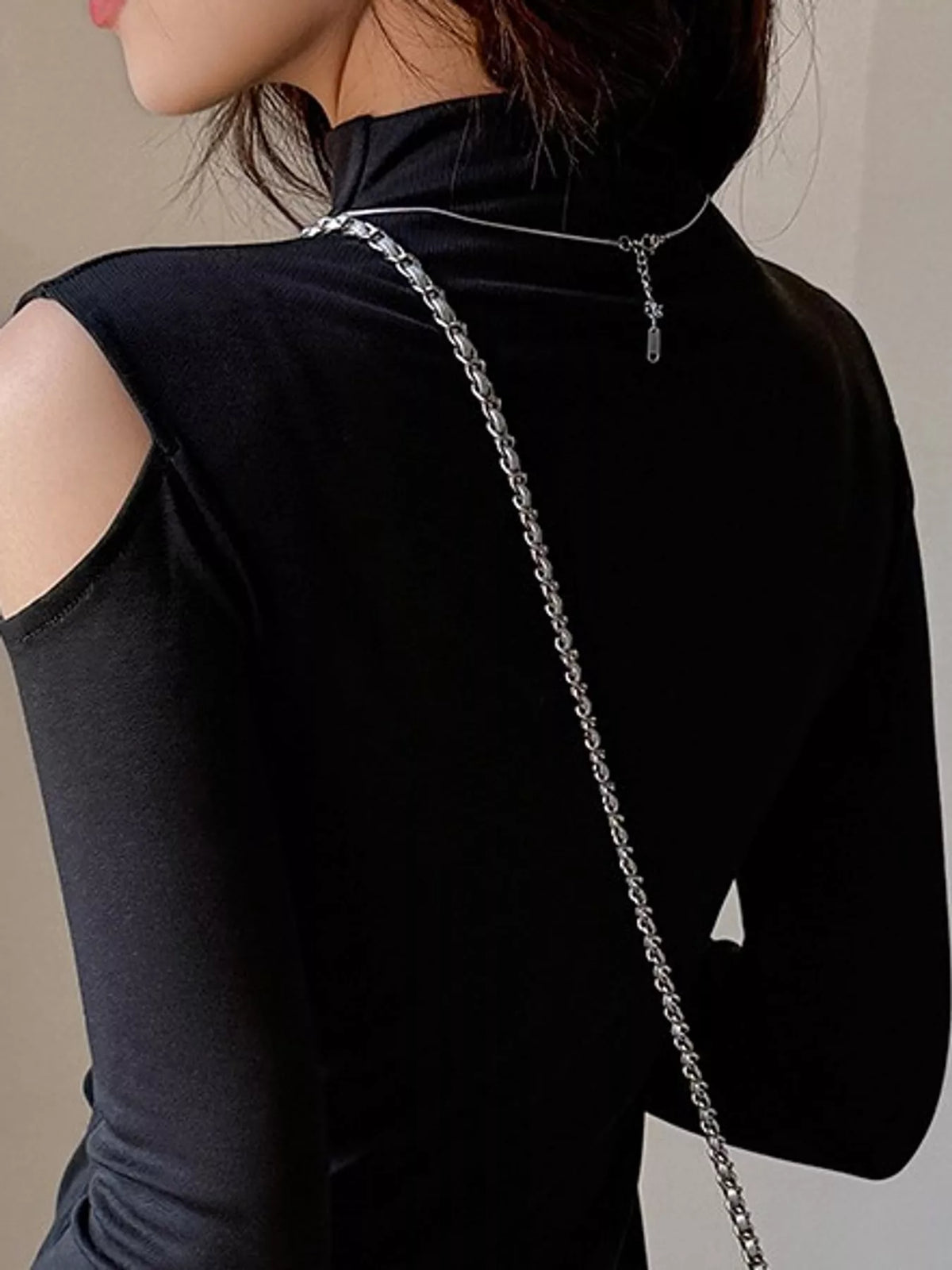 Black mock neck cold-shoulder t-shirt, back view