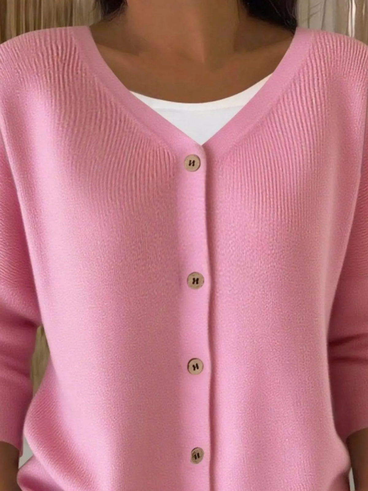Pink ribbed button-front cardigan, neckline close-up