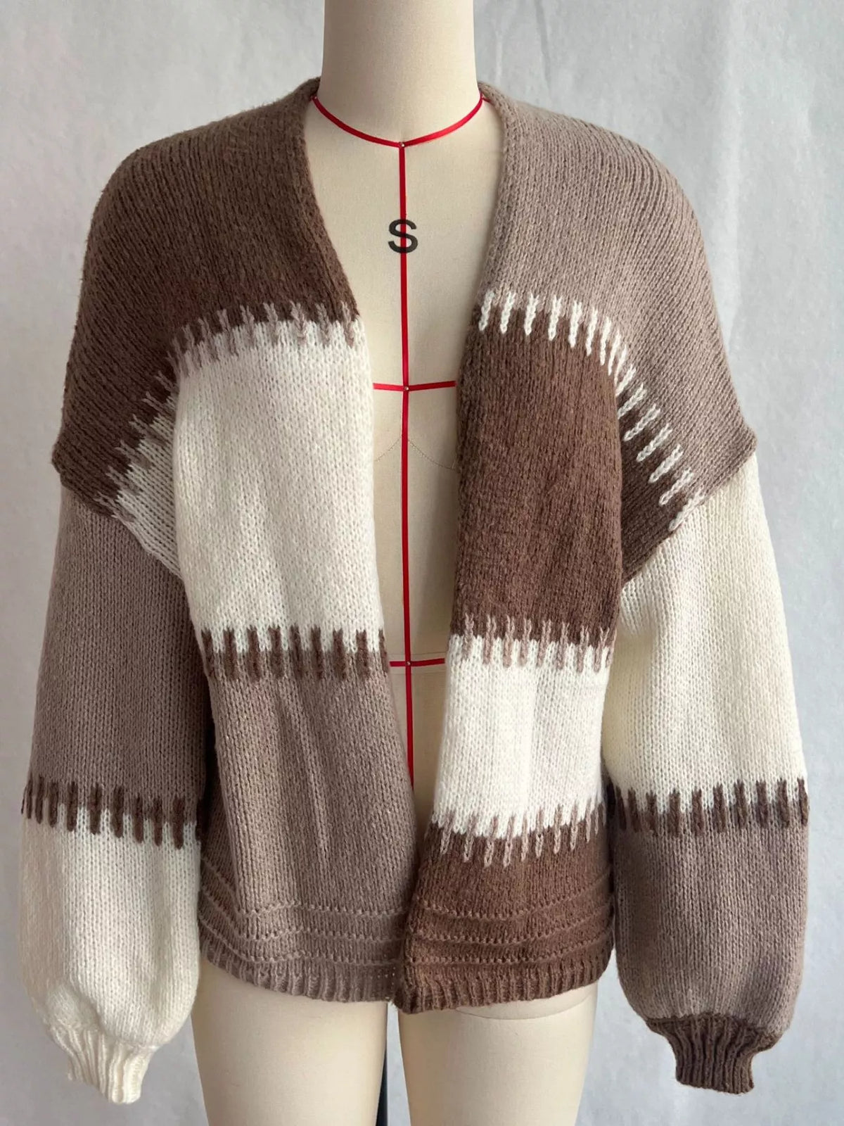 Brown color-block v-neck cardigan, front on dress form.
