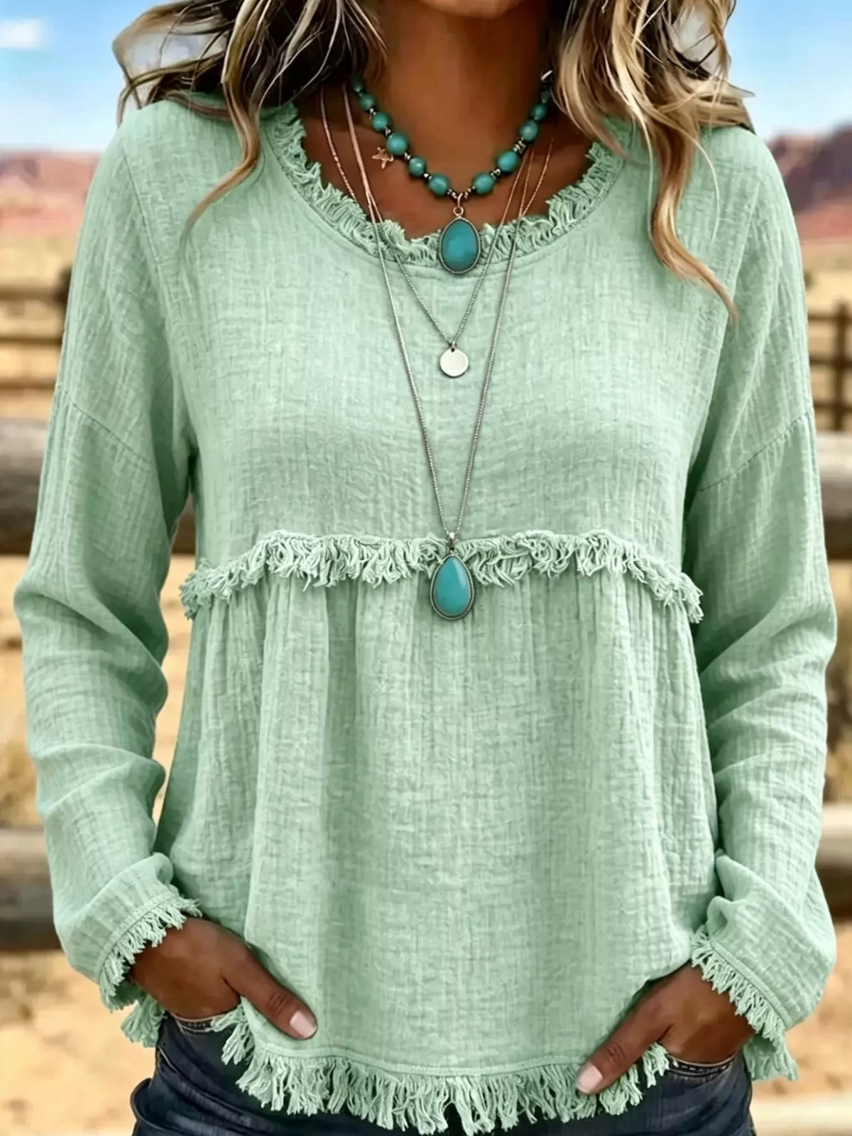 Pale green frayed hem textured blouse, front view