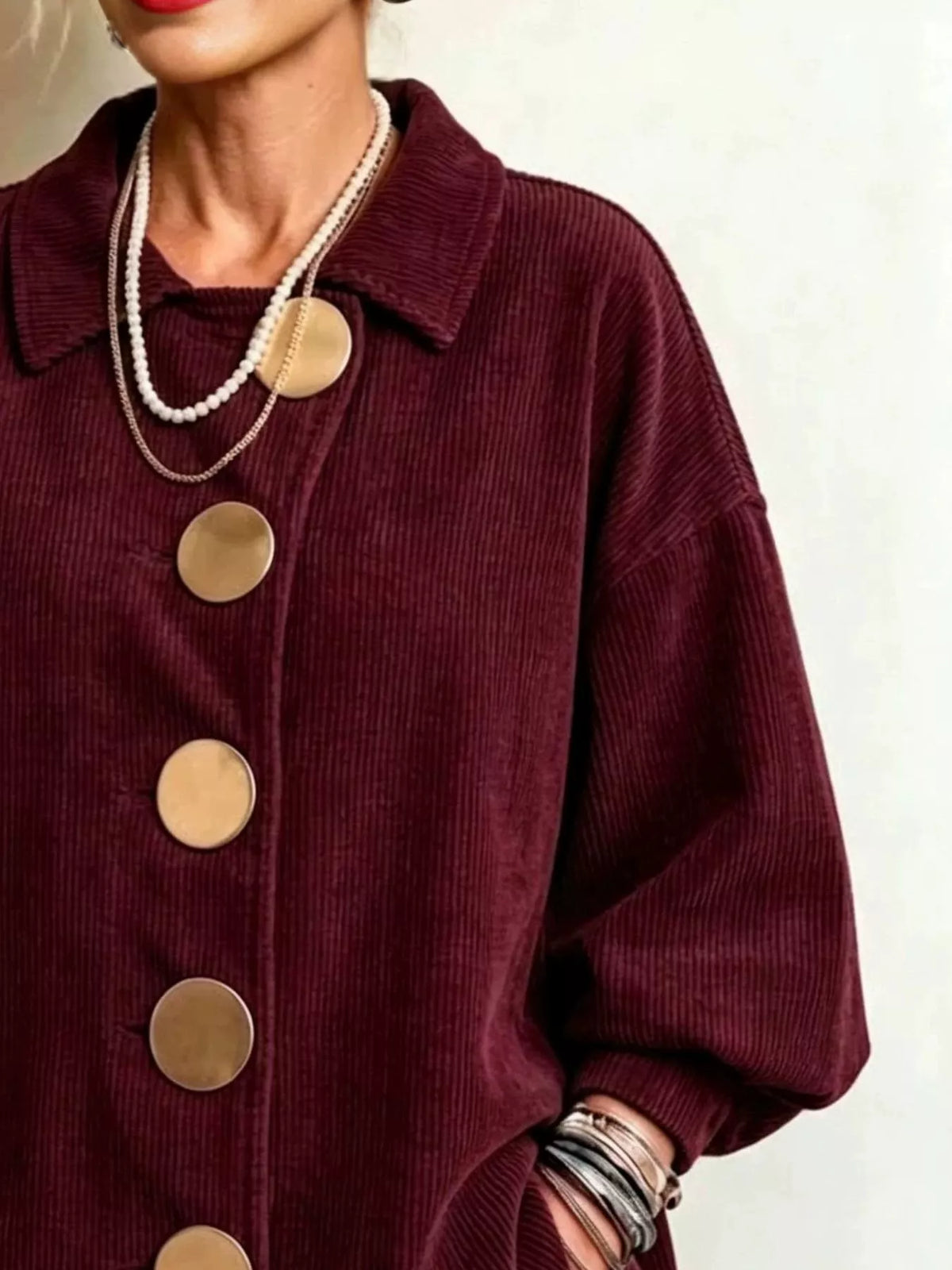 Burgundy corduroy button-down jacket, collar, gold-tone buttons, and sleeve
