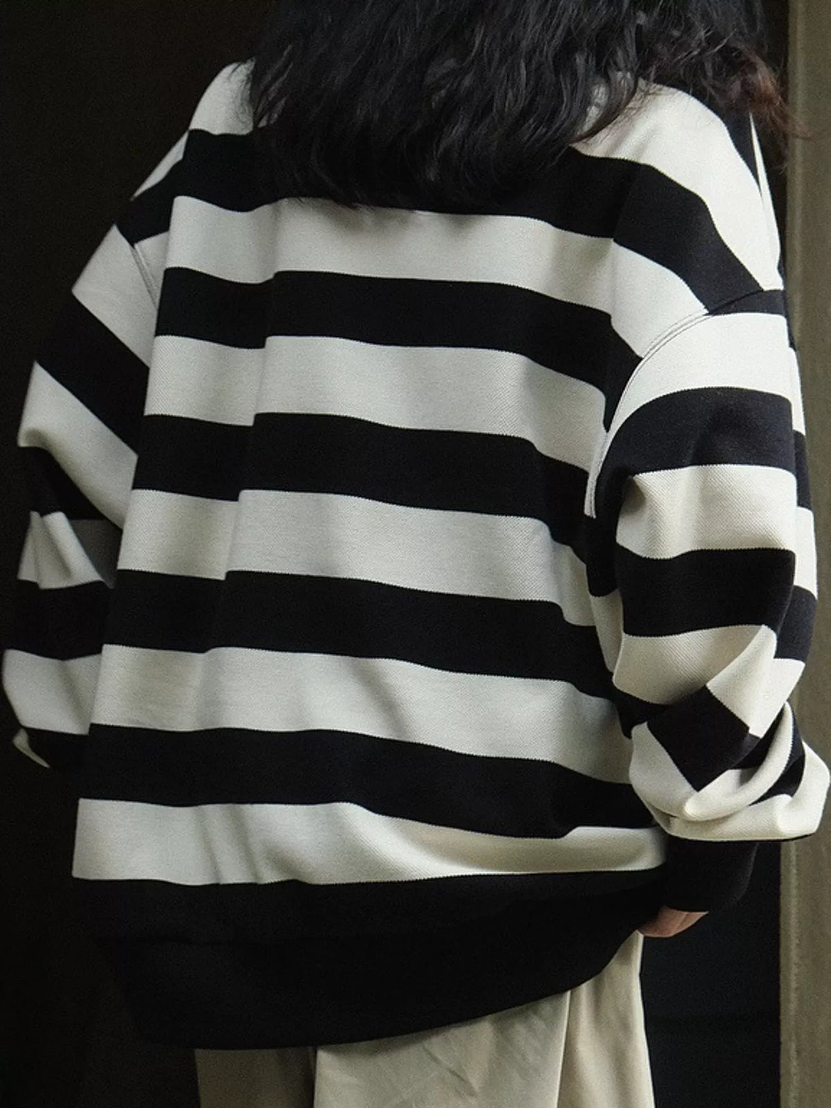 Black oversized striped crewneck sweatshirt, back view