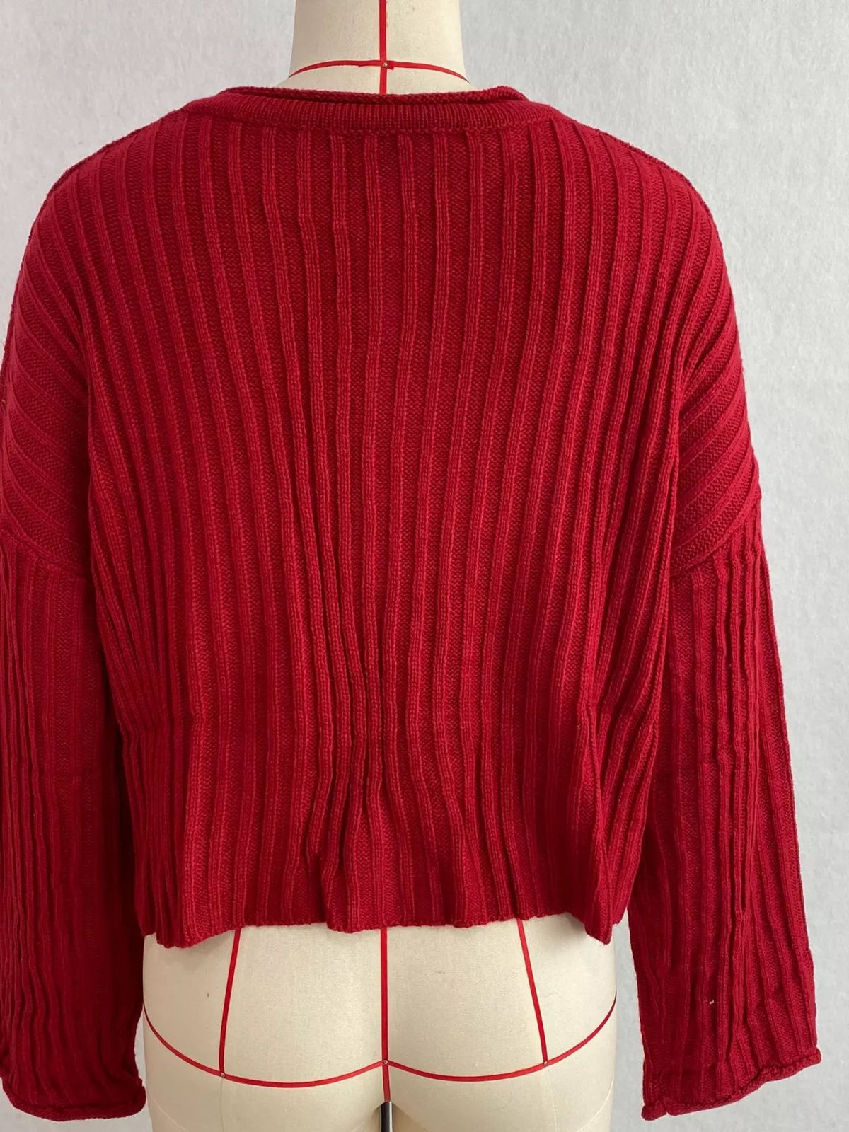 Red ribbed lace-up cropped sweater, back on dress form.