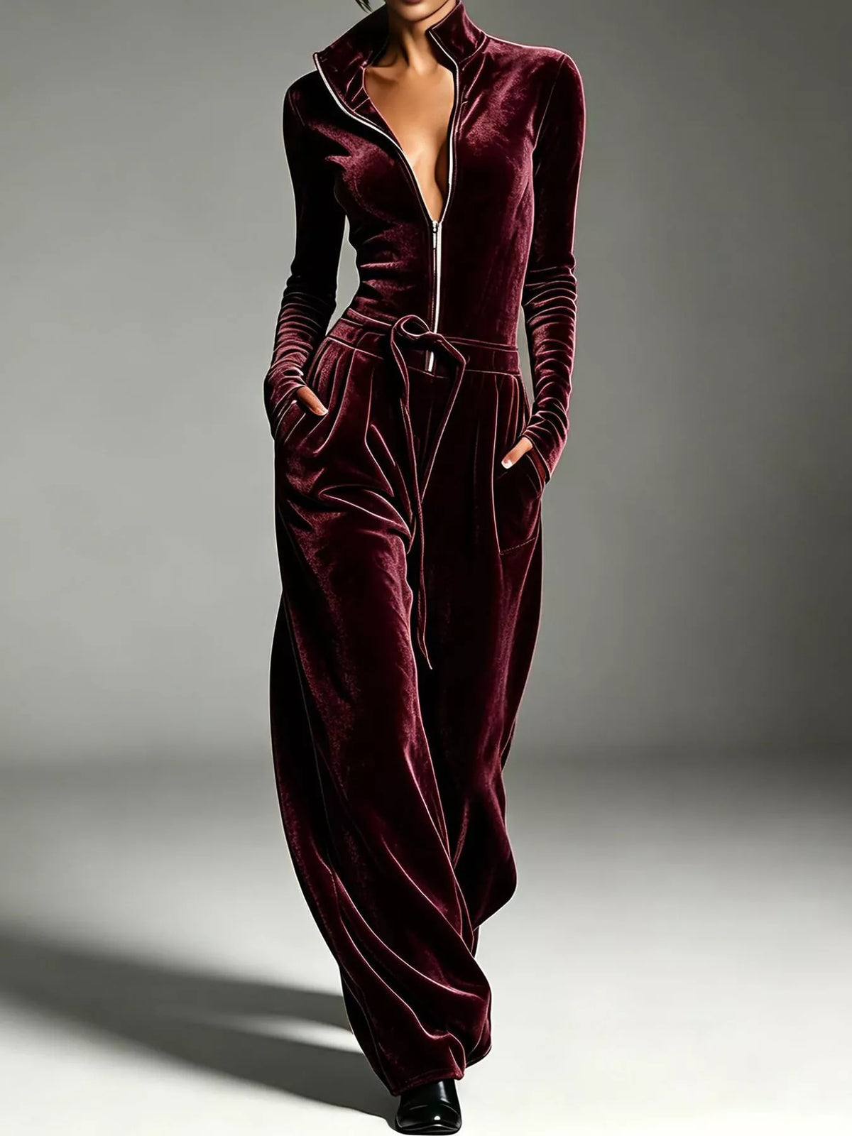 Burgundy velvet zip up jumpsuit with tie waist, front view