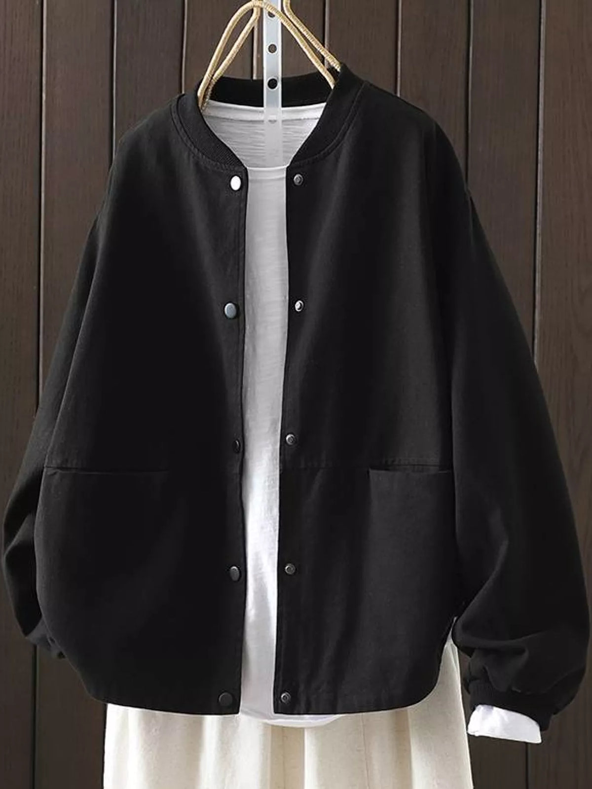 Black snap front dropped shoulder jacket, front view