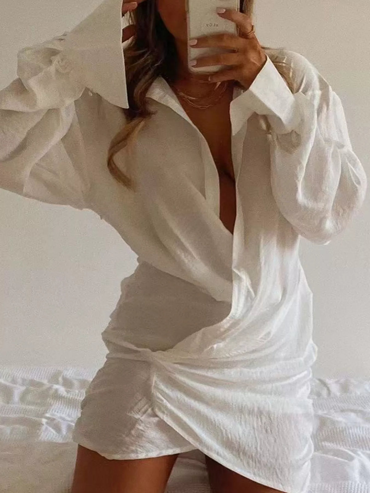 White deep v-neck ruched asymmetric mini dress, mirror front view.