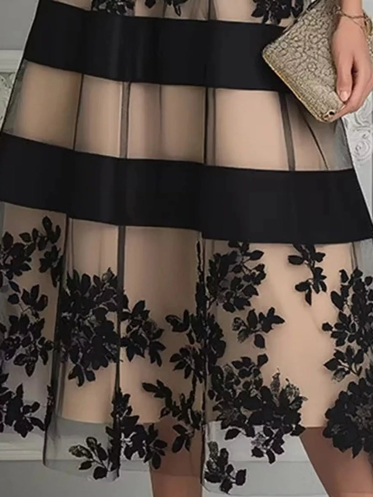 Beige and black floral tulle midi dress with black horizontal trim, skirt overlay detail