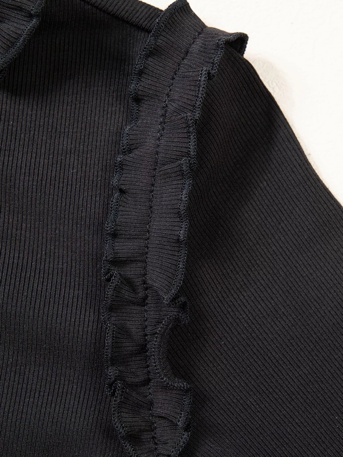 Shoulder seam and ruffle on black round neck frill detail long sleeve top