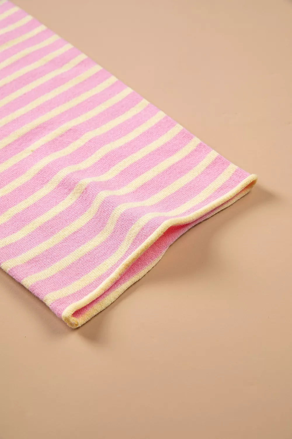 Pink and yellow striped button-detail sweater, cuff detail