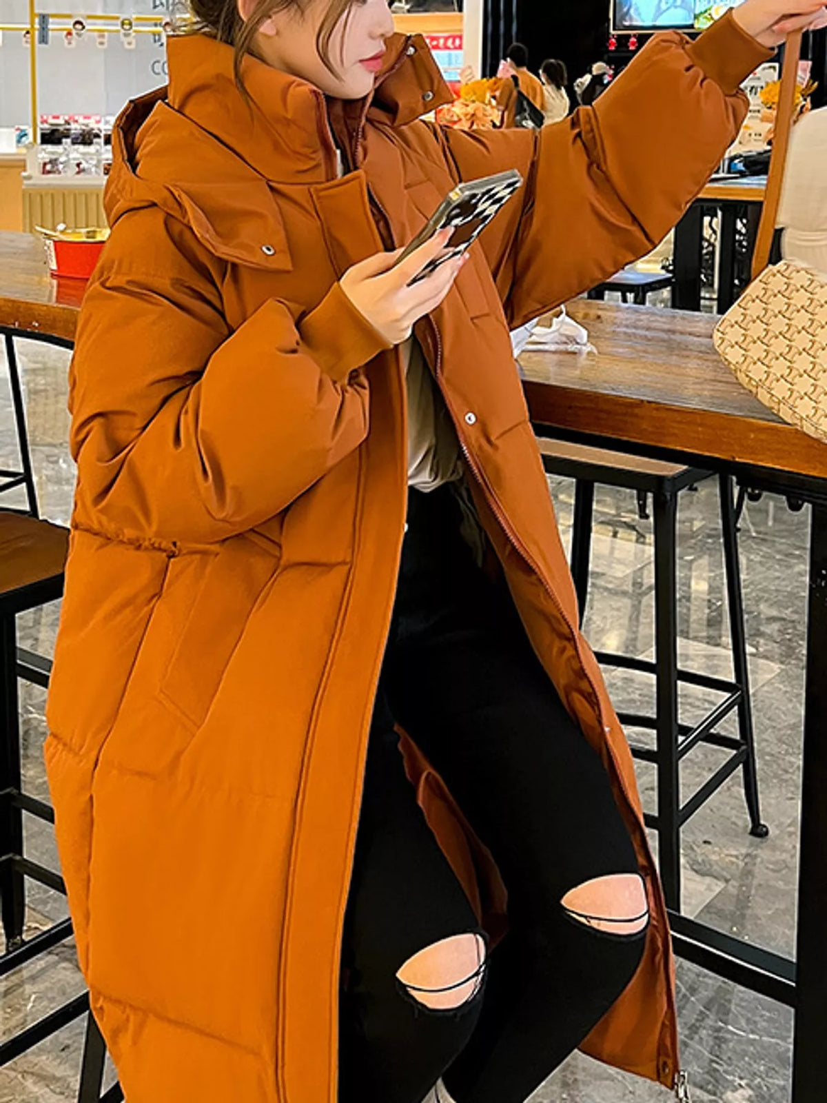 Longline puffer coat, orange sleeve view