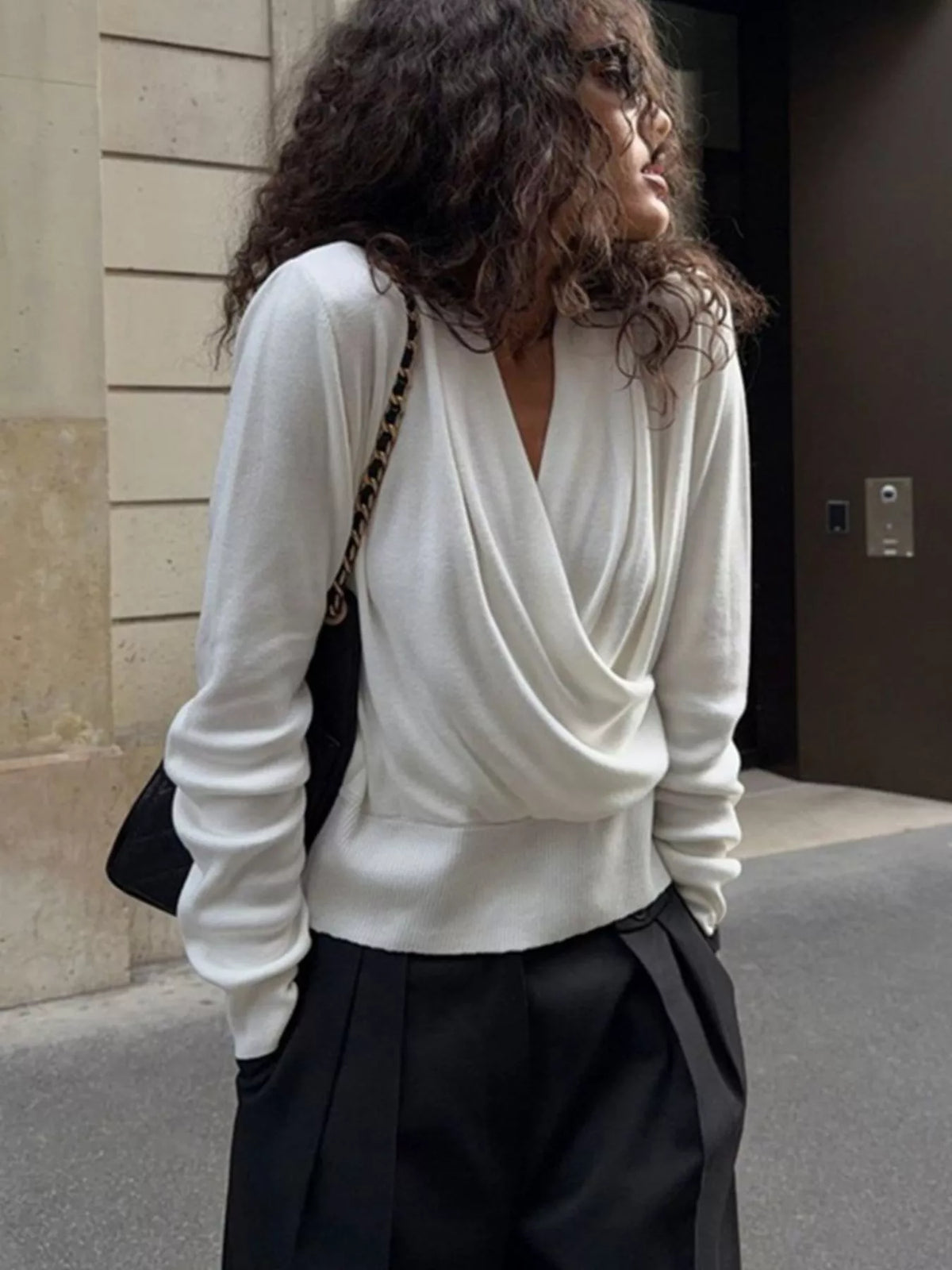White wrap-front sweater, front view with head down