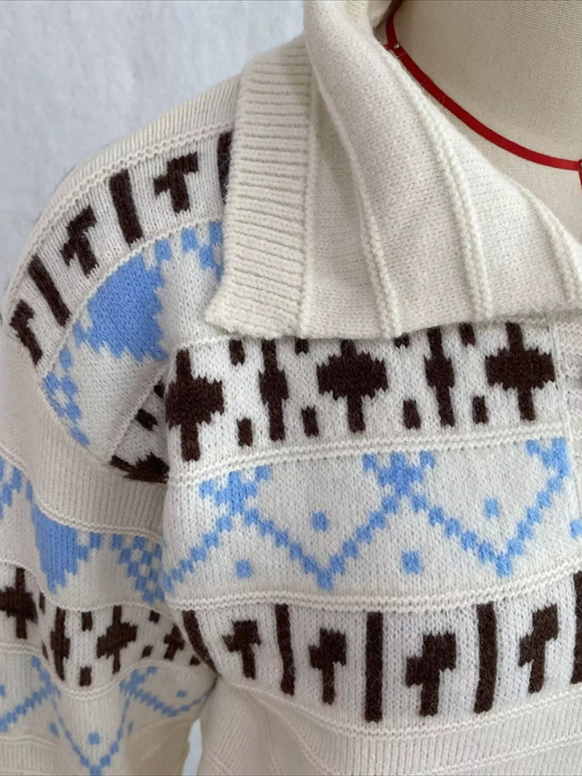 Cream fair isle polo-collar sweater, collar detail.
