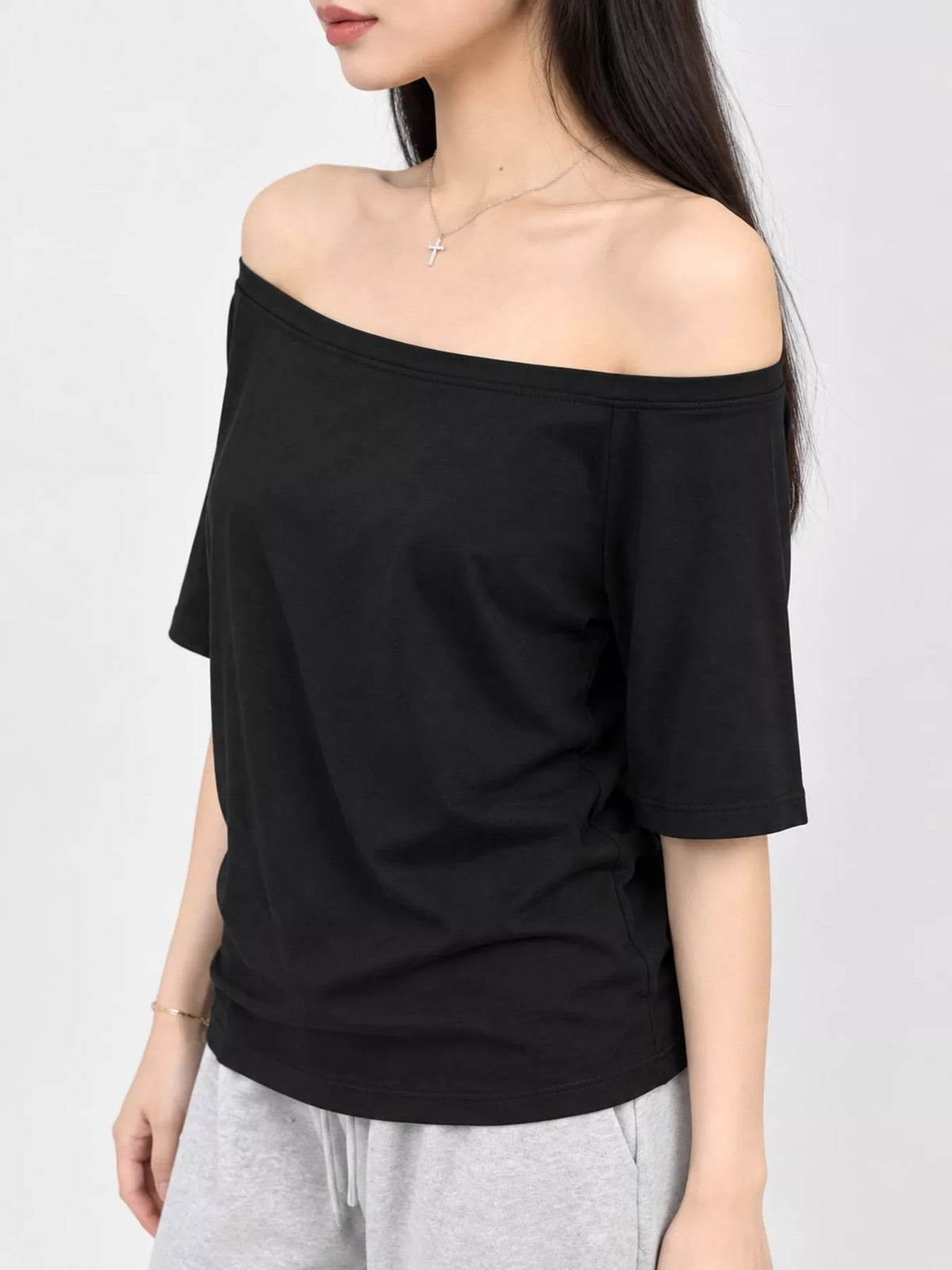 Black asymmetric-neck T-shirt, front view