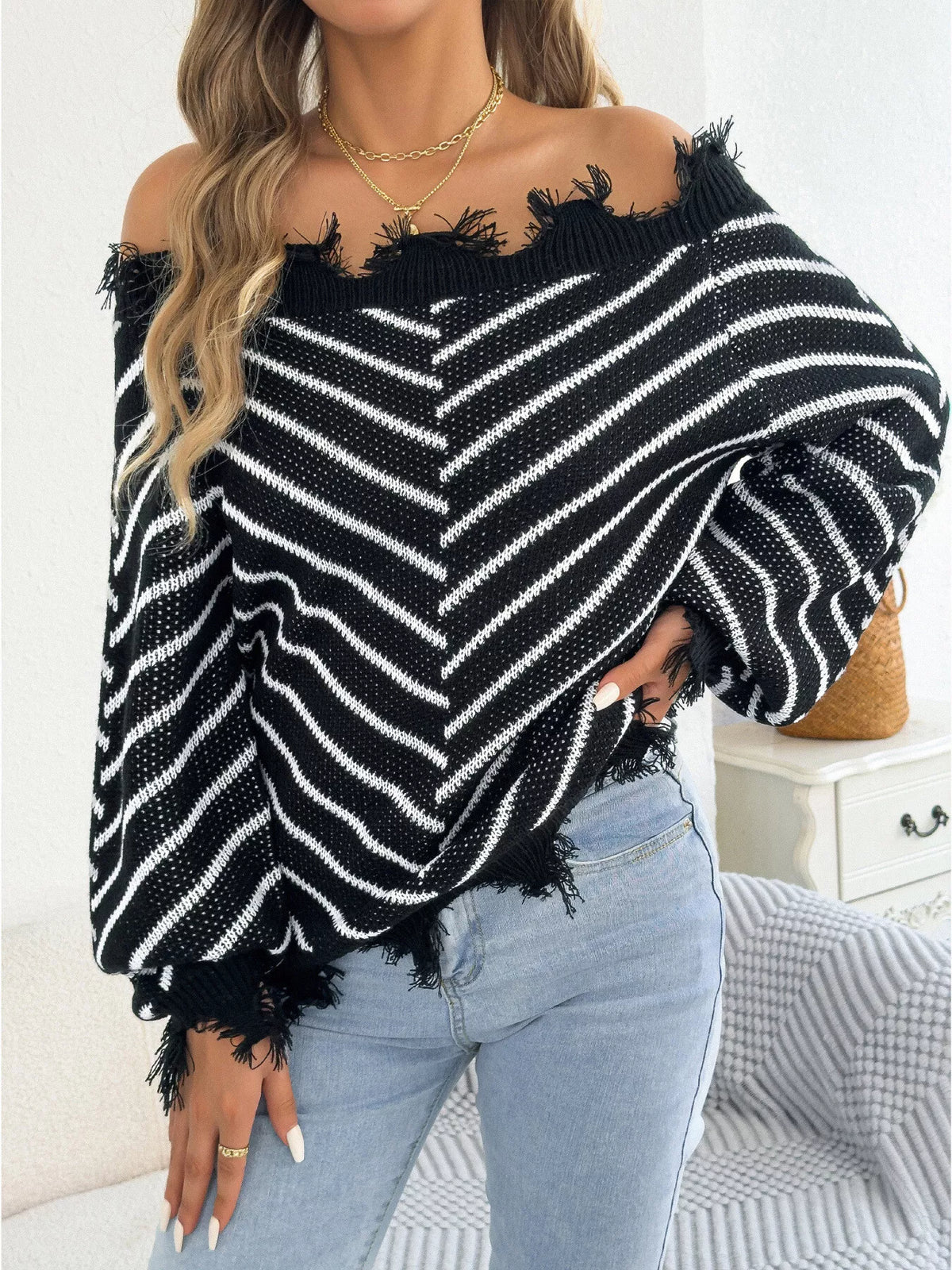 Black off-shoulder distressed striped sweater