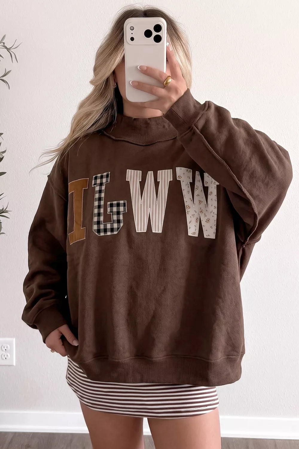 Brown wwjd patchwork graphic mock-neck sweatshirt, mirror front view.
